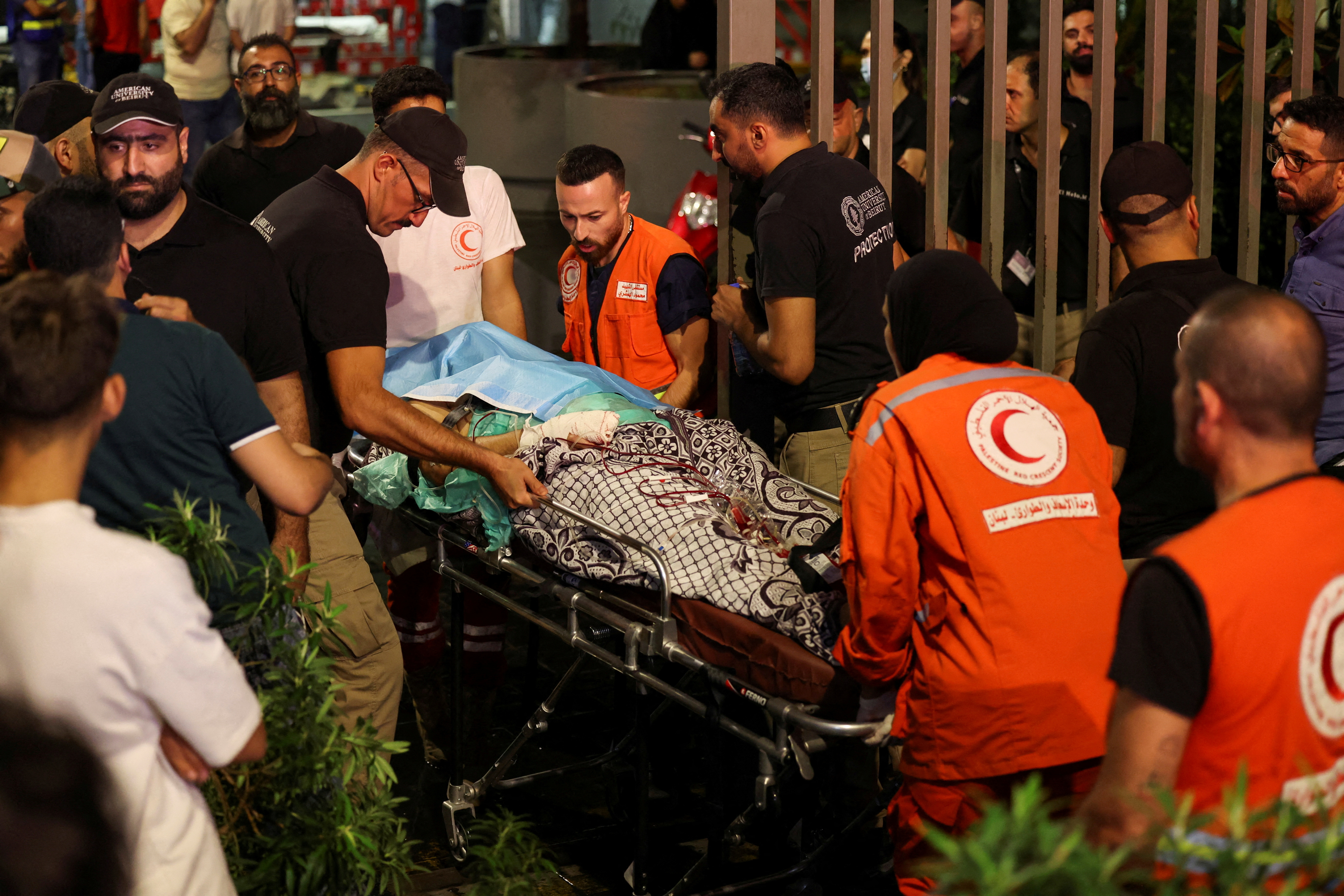 A person is carried on a stretcher outside American University of Beirut Medical Center