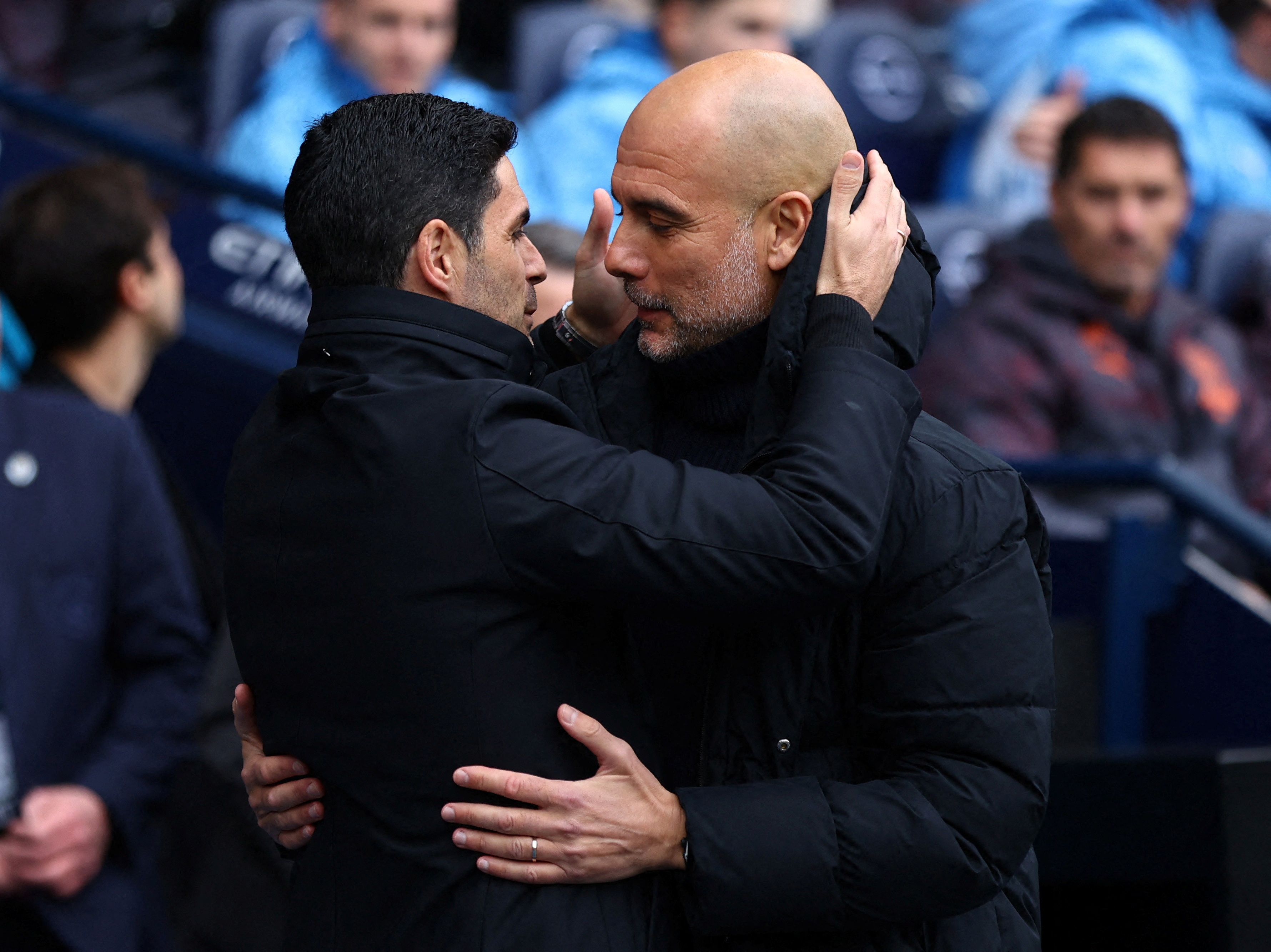 Arsenal manager Mikel Arteta, left, and City manager Pep Guardiola exchange a hug before a game