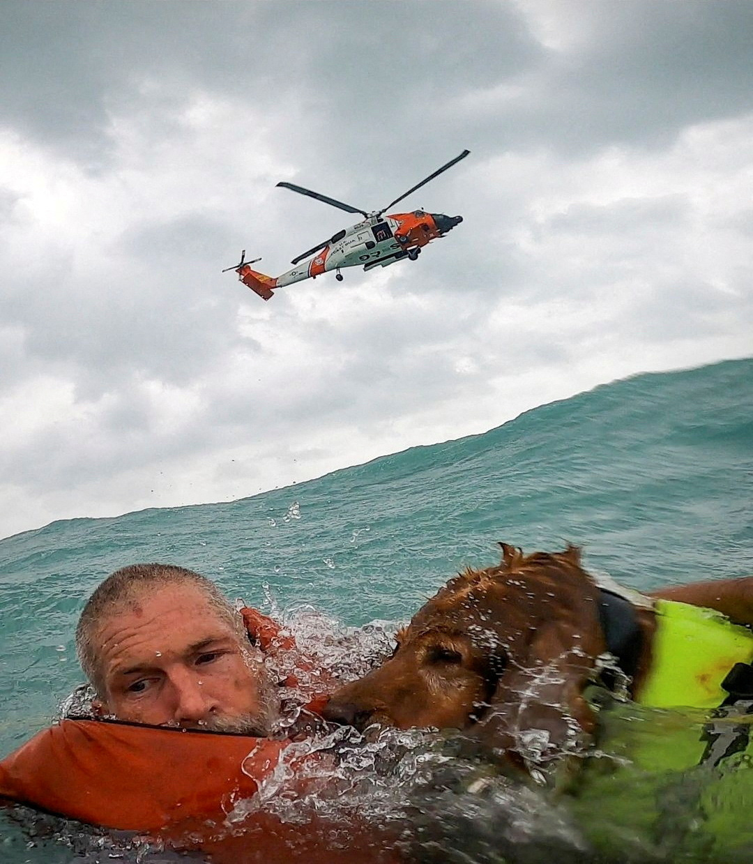 A US Coastguard Air Station crew rescues a man and his dog during Hurricane Helene after his sailboat became disabled
