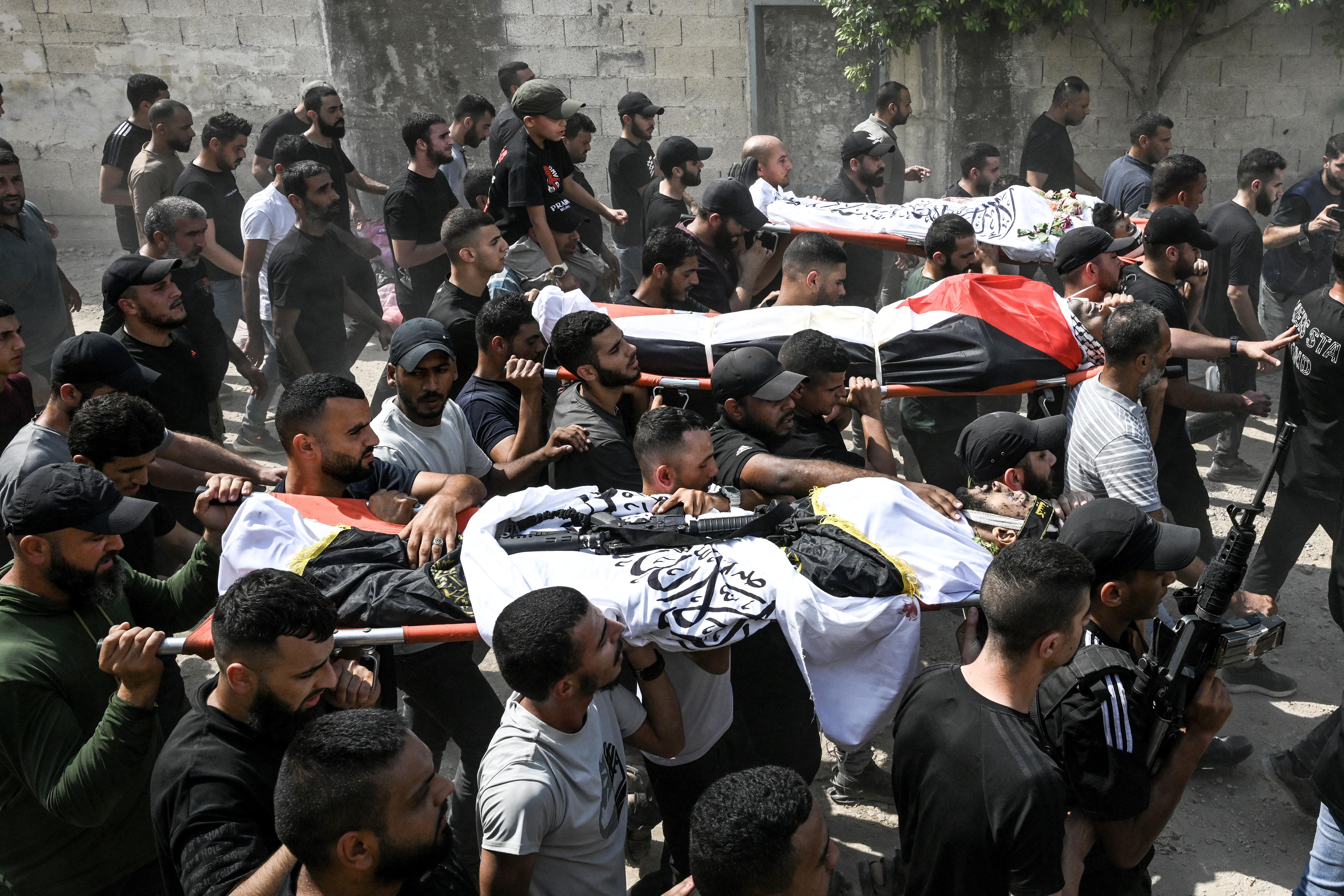 Mourners carry the bodies of Palestinians killed during an Israel raid in the northern part of the West Bank, during their funeral in the Jenin refugee camp