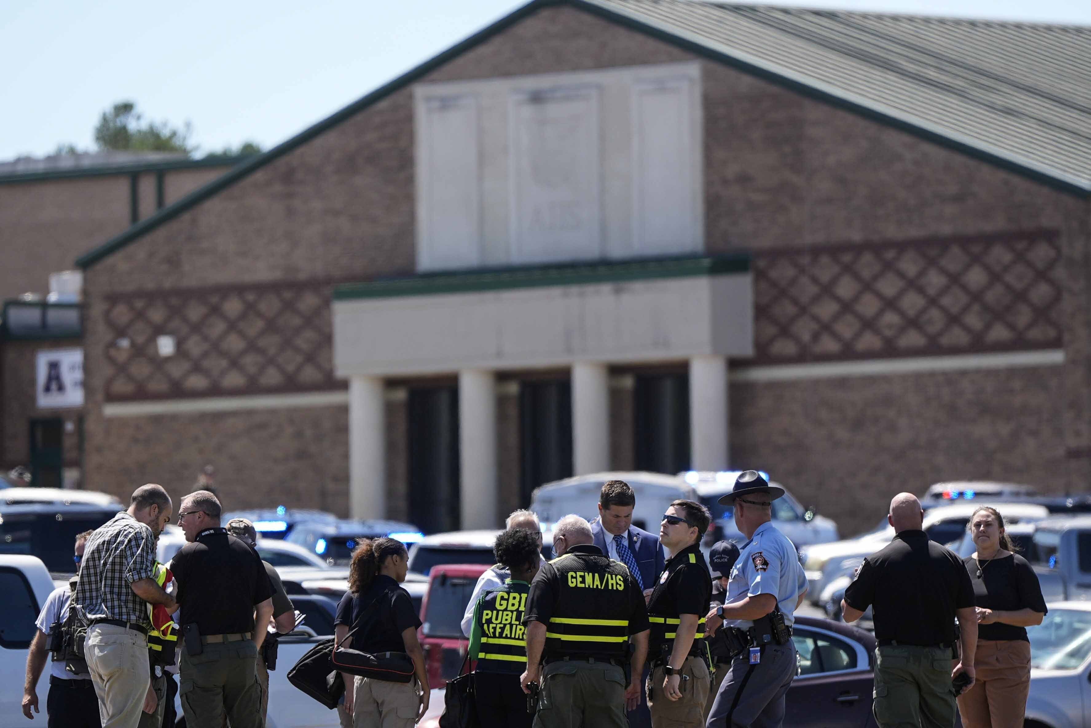 Police gather outside Apalachee High School after a shooting at the school on September 4, 2024