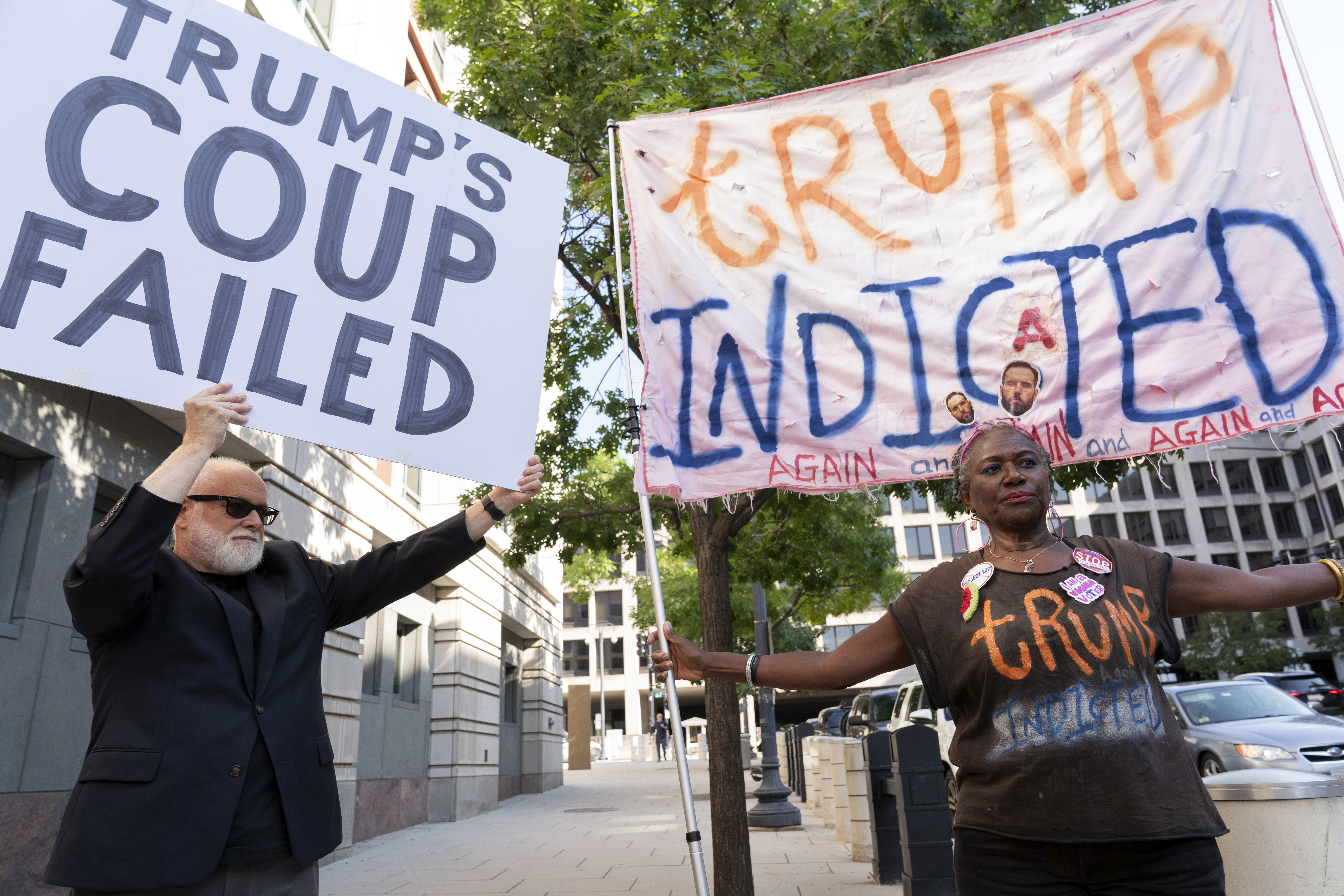 Bill Christeson, left, and Nadine Seiler protest outside of the E Barrett Prettyman Federal Courthouse on September 5