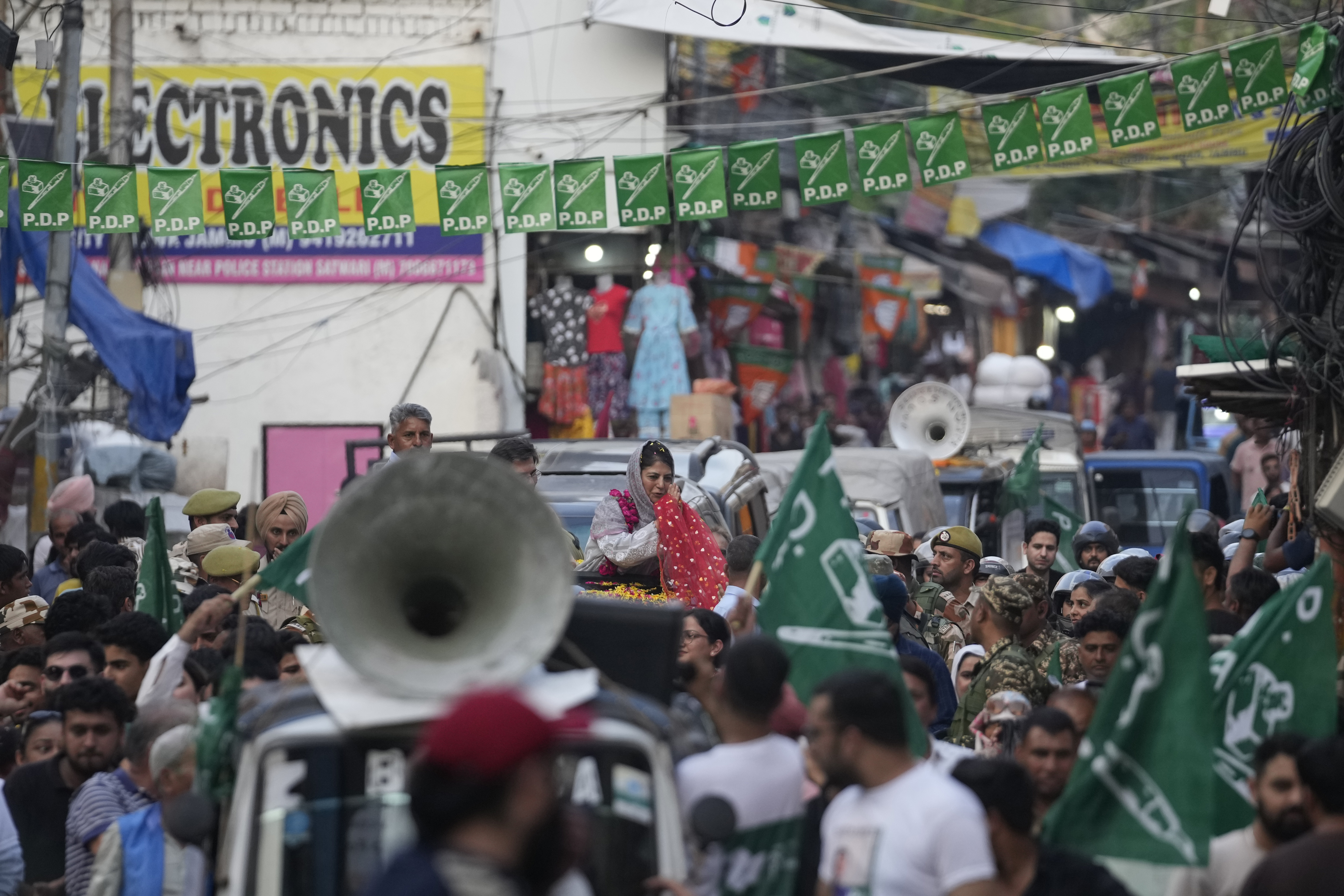 Mehbooba Mufti, leader of the People’s Democratic Party (PDP), greets supporters during a campaign rally in Jammu