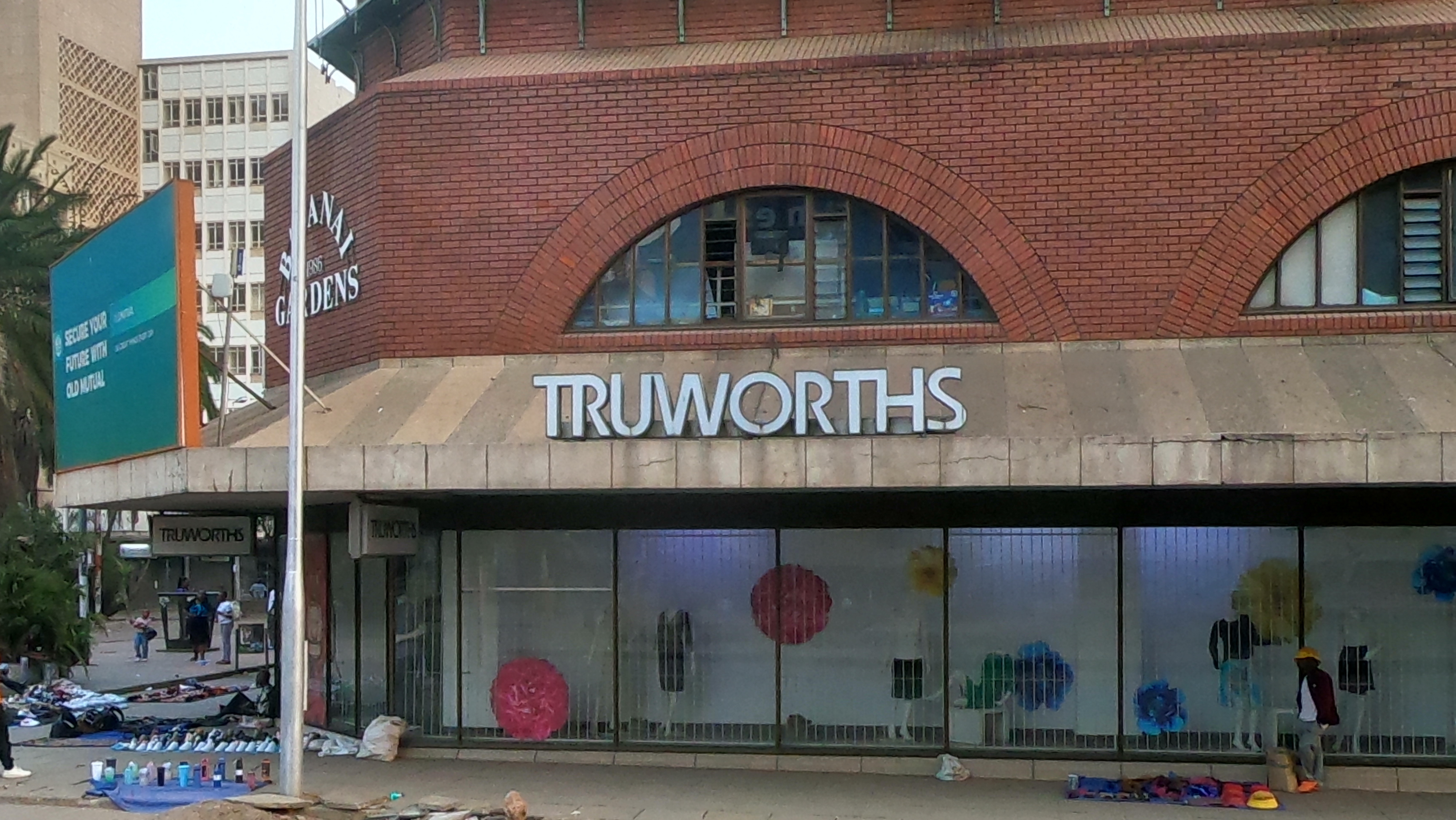 People sell preloved and new cheap clothes on the pavement outside a Truworths branch in Harare. Truworths said it could not compete with the secondhand imported clothes market