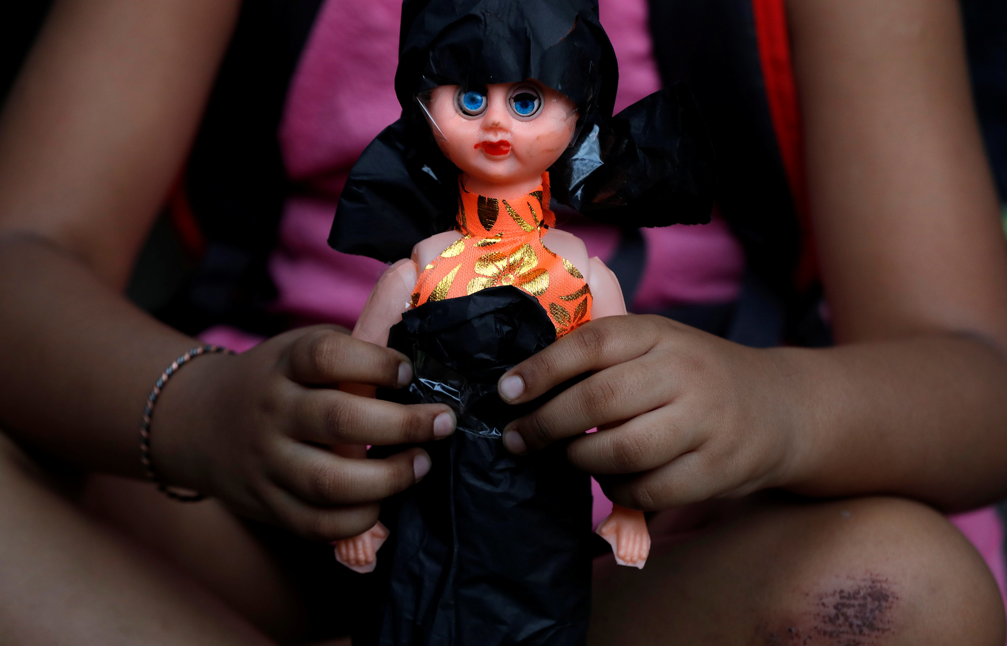 A child attends a protest against the rape of an eight-year-old girl in Kathua, near Jammu and a teenager in Unnao, Uttar Pradesh state, in New Delhi, India, April 15, 2018. REUTERS/Cathal McNaughton