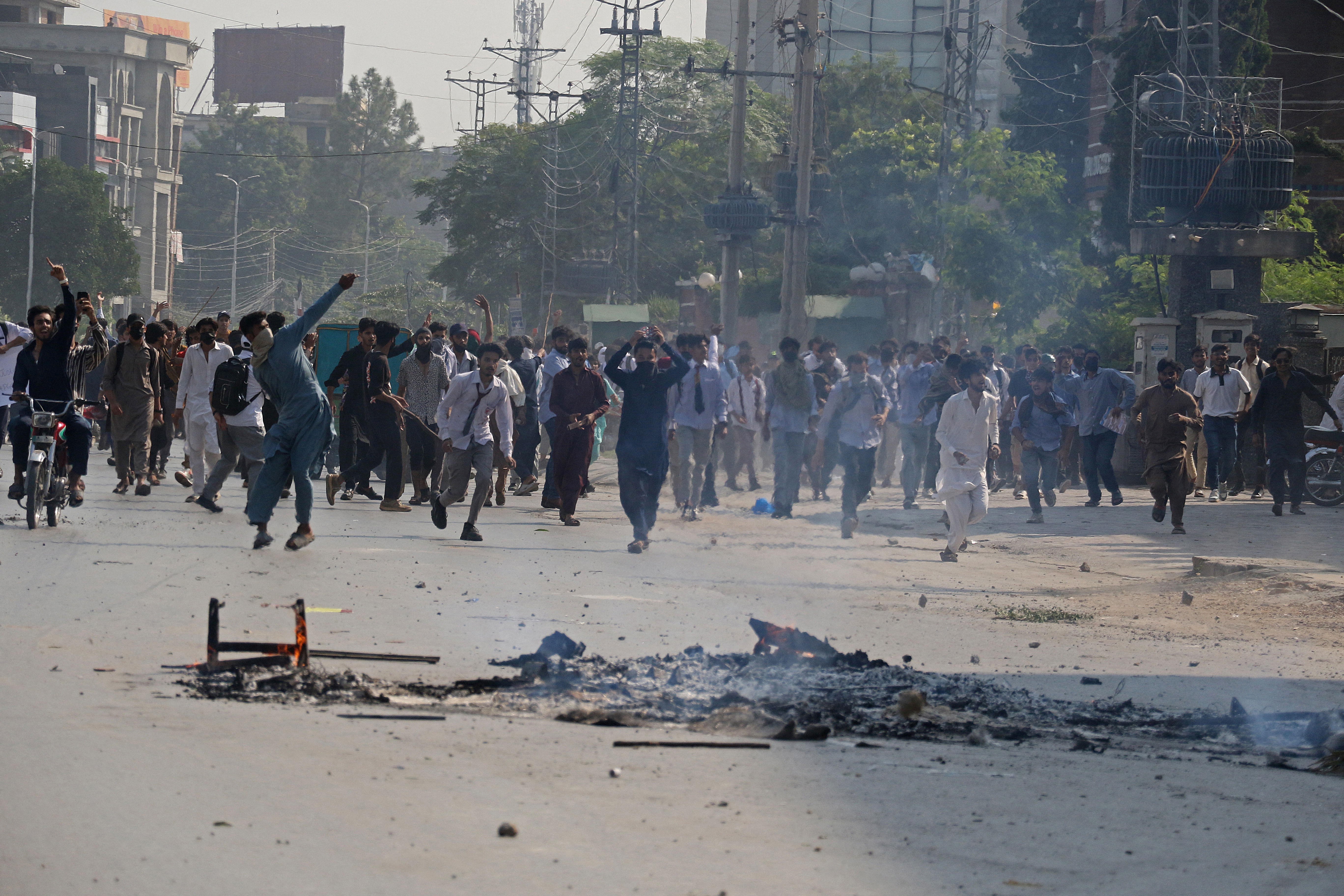 Students hurl stones at security personnel during a demonstration to condemn the alleged rape of a female student, in Rawalpindi, Pakistan, on October 17, 2024
