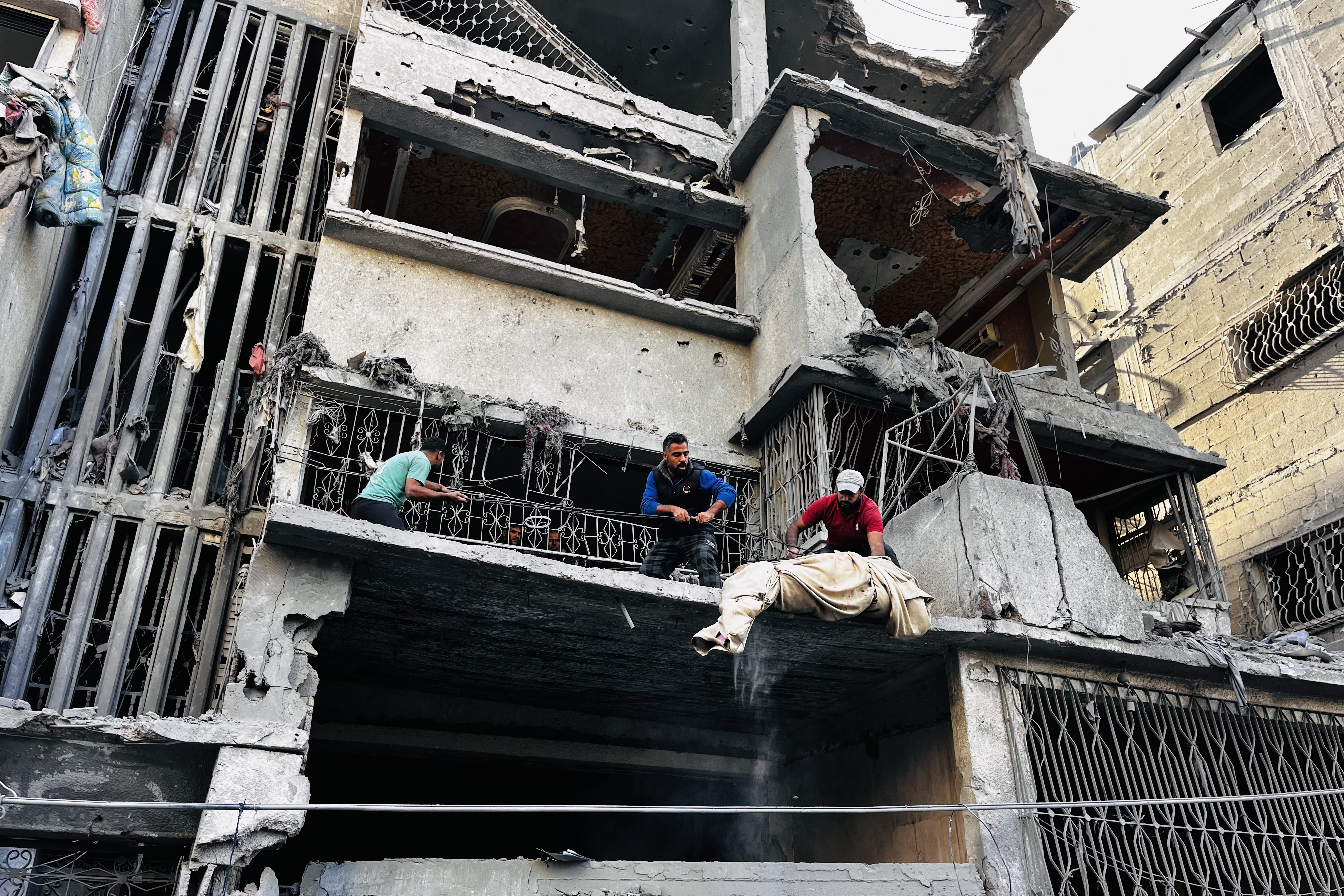 Palestinian first responders remove a body from the rubble of a building following an Israeli strike in Beit Lahia, in the northern Gaza Strip, on October 29, 2024,