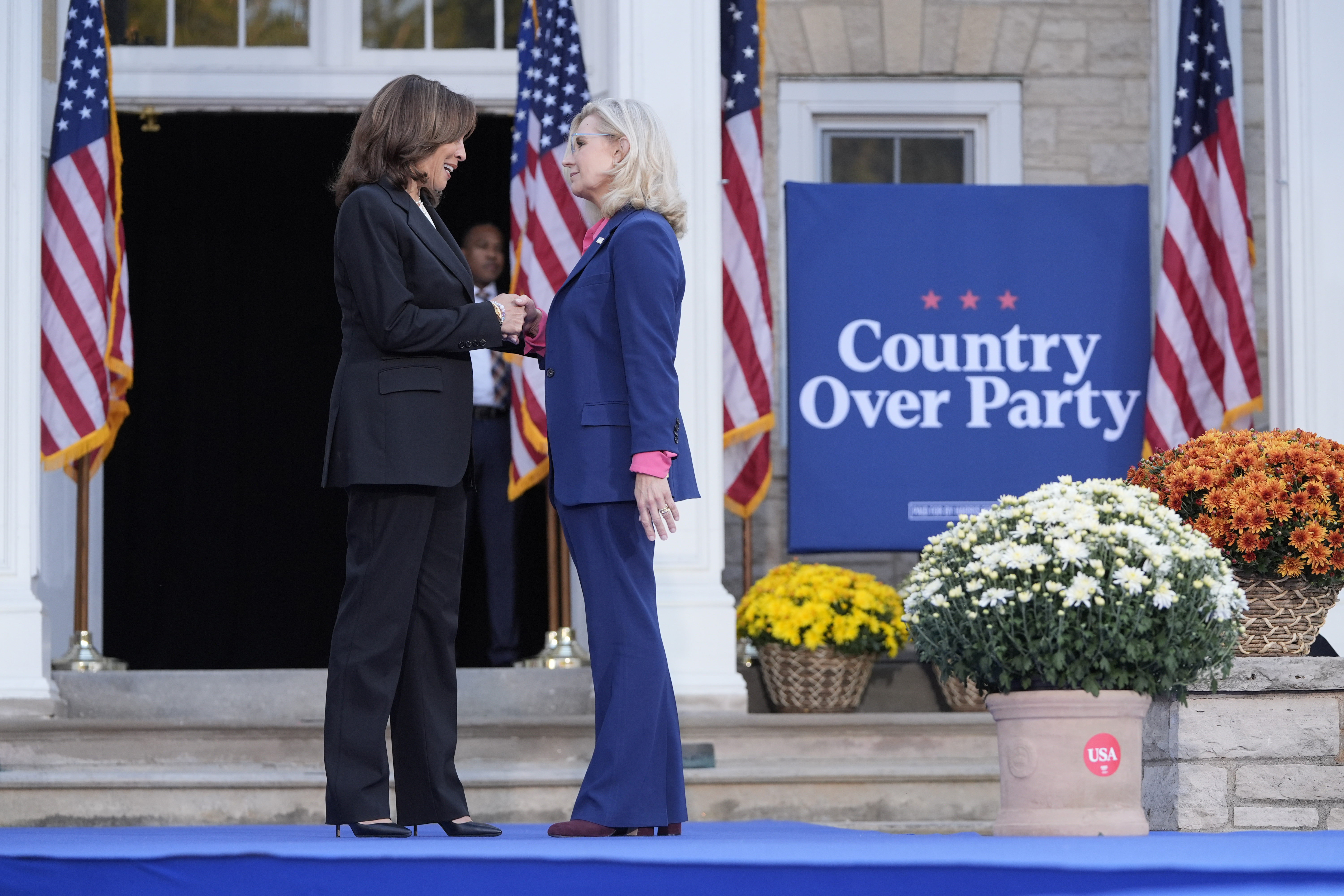 Vice President Kamala Harris, left, shakes hands with former Congresswoman Liz Cheney in Ripon, Wisconsin
