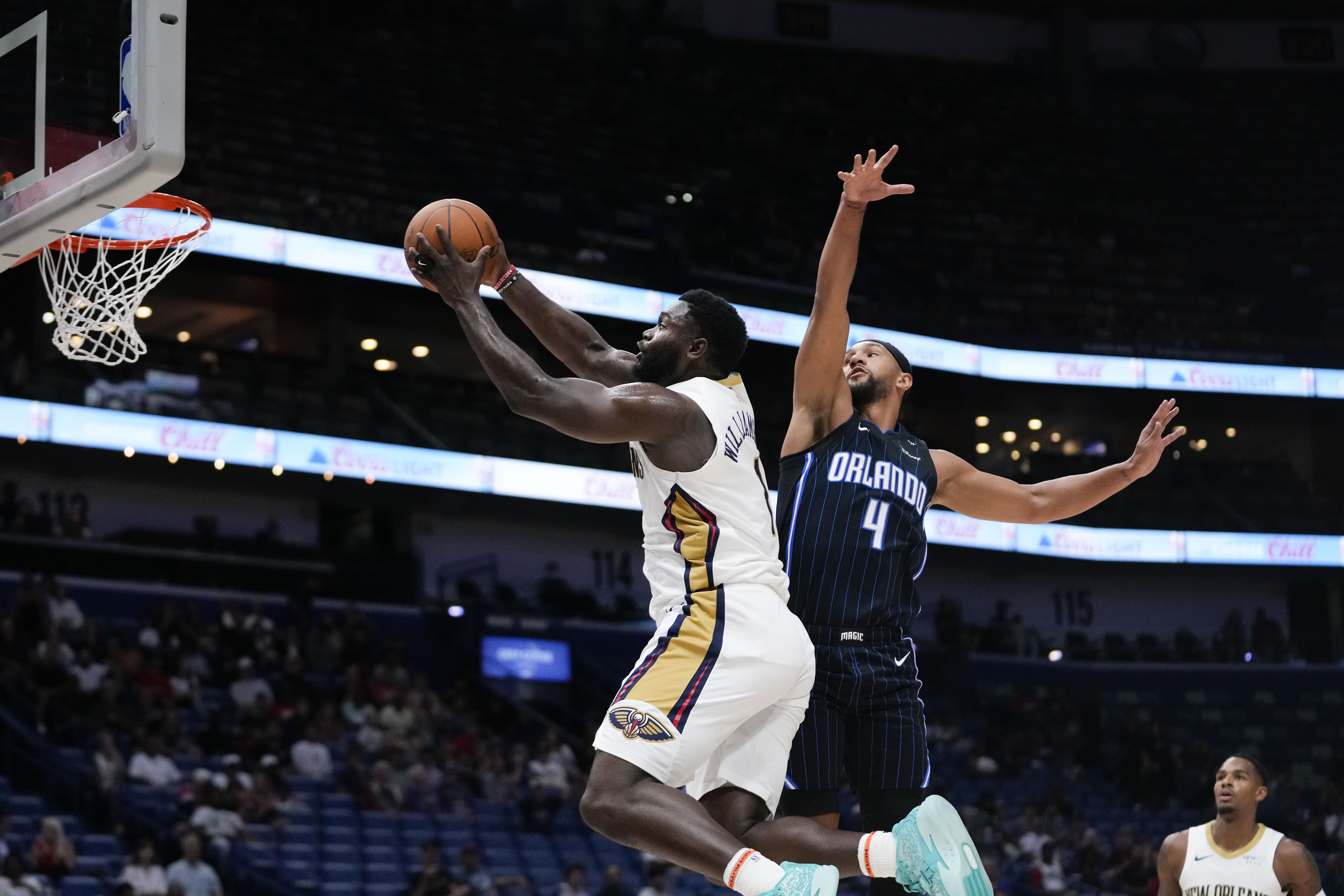 New Orleans Pelicans forward Zion Williamson goes to the basket against Orlando Magic guard Jalen Suggs in an NBA preseason basketball game in New Orleans, Louisiana on October 7, 2024