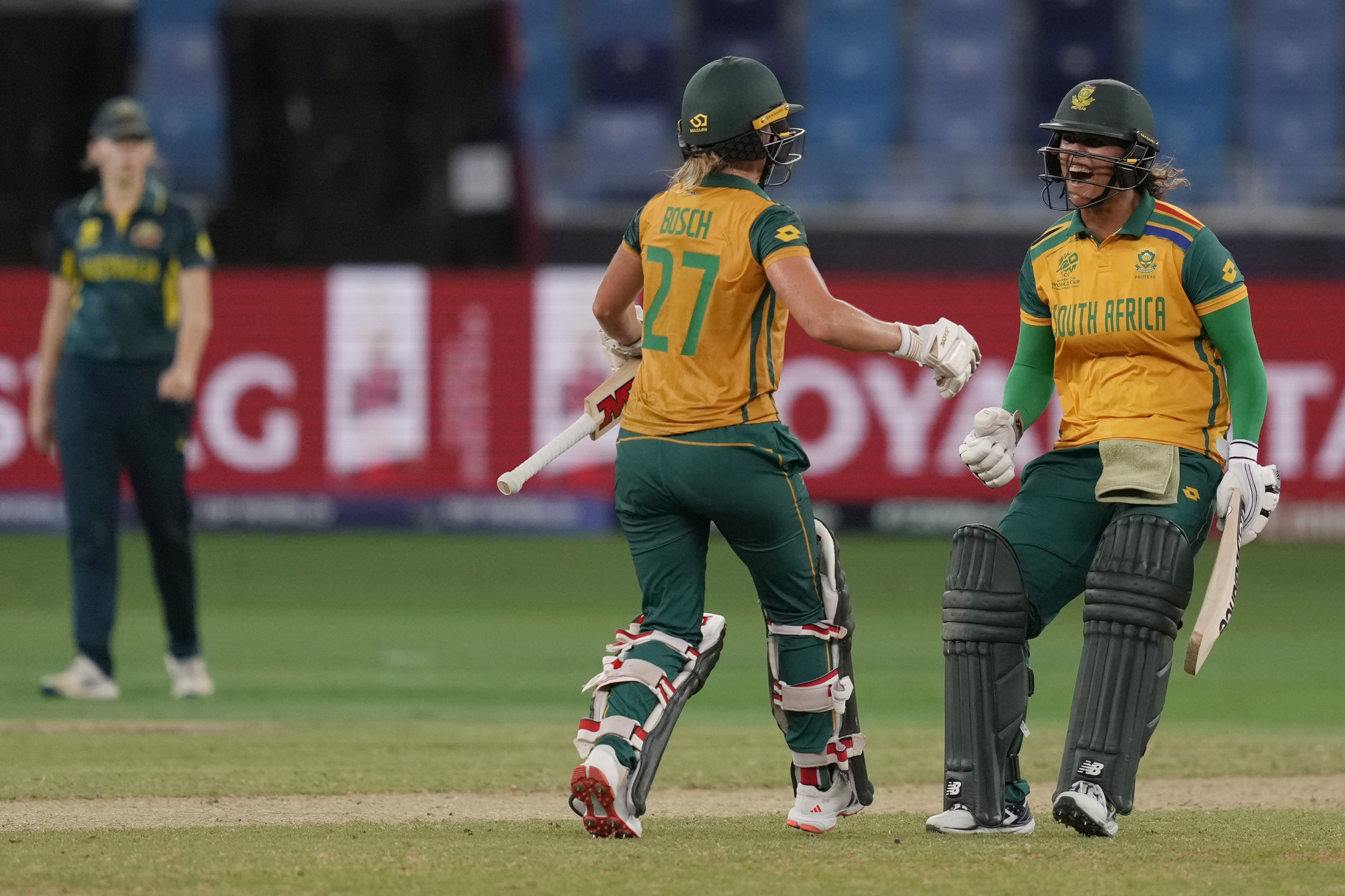 South Africa's Anneke Bosch and Chloé Tryon celebrate after wining against Australia during the ICC Women's T20 World Cup 2024 semi-final match at Dubai International Cricket Stadium, United Arab Emirates, Thursday, Oct. 17, 2024. (AP Photo/Altaf Qadri)