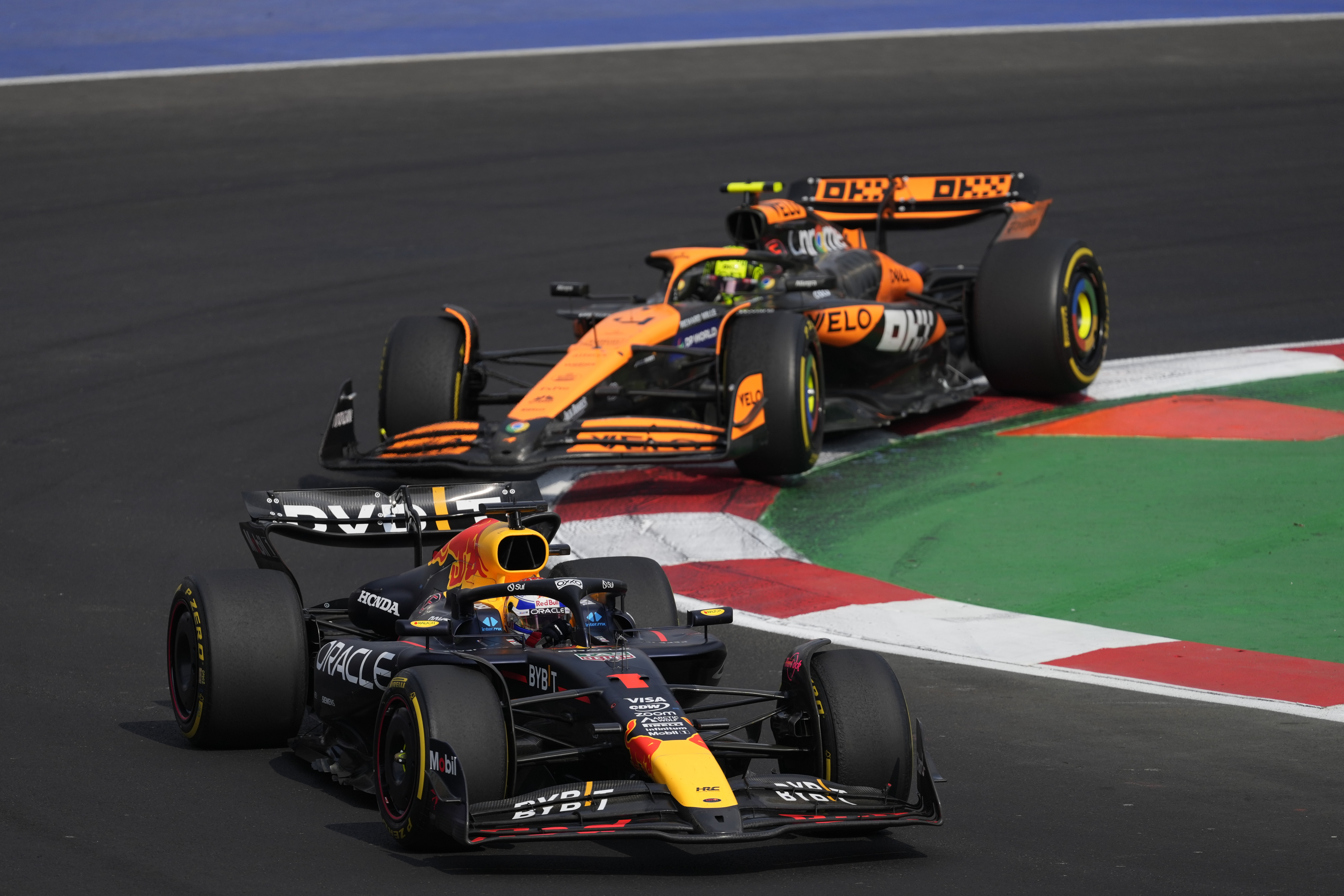 Max Verstappen, of Netherlands, steers his Red Bull followed by McLaren driver Lando Norris of Britain during the Formula One Mexico Grand Prix auto race at the Hermanos Rodriguez racetrack in Mexico City, Sunday, Oct. 27, 2024. (AP Photo/Eduardo Verdugo)