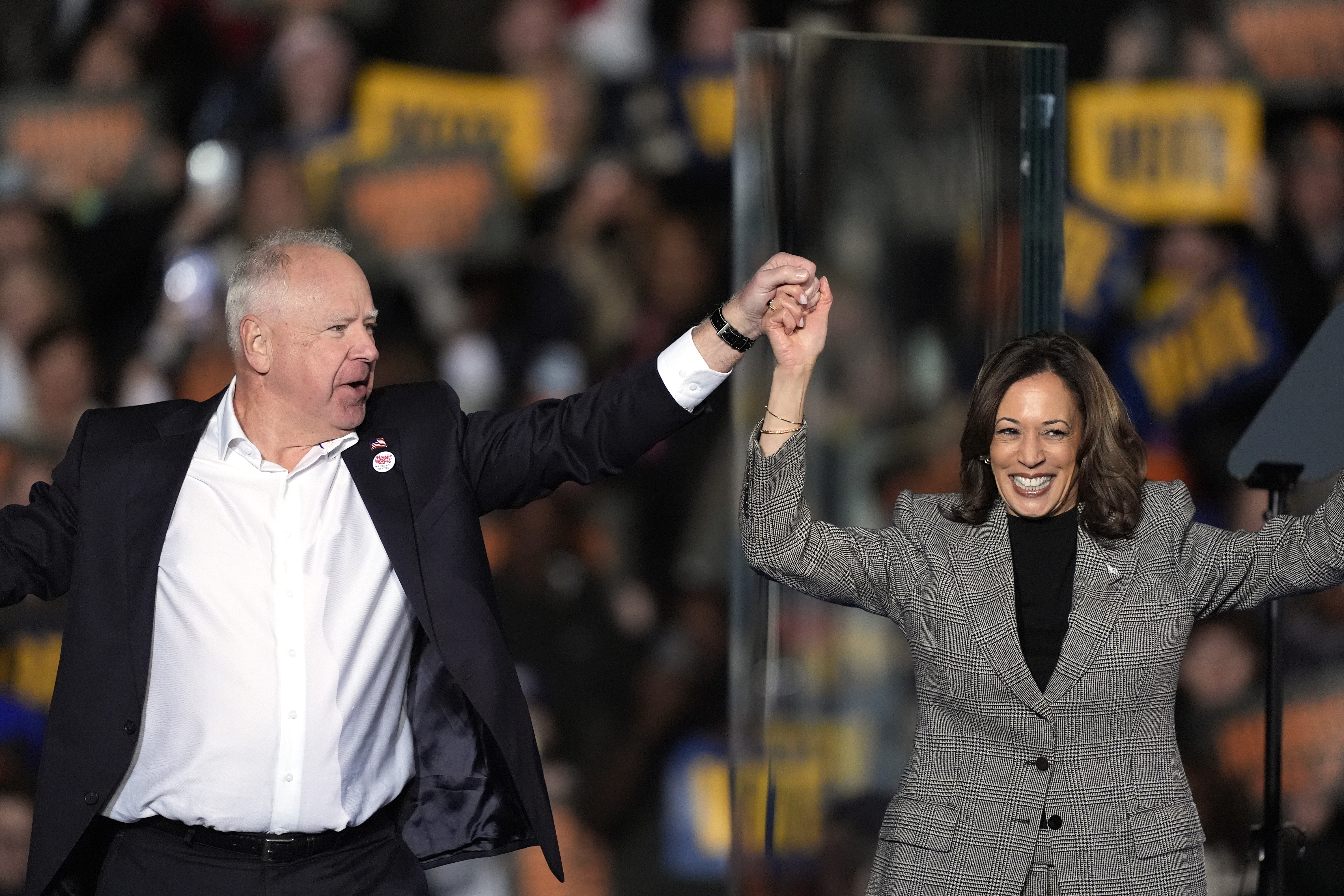 Harris, right, and her running mate Minnesota Governor Tim Walz depart after speaking during a campaign rally