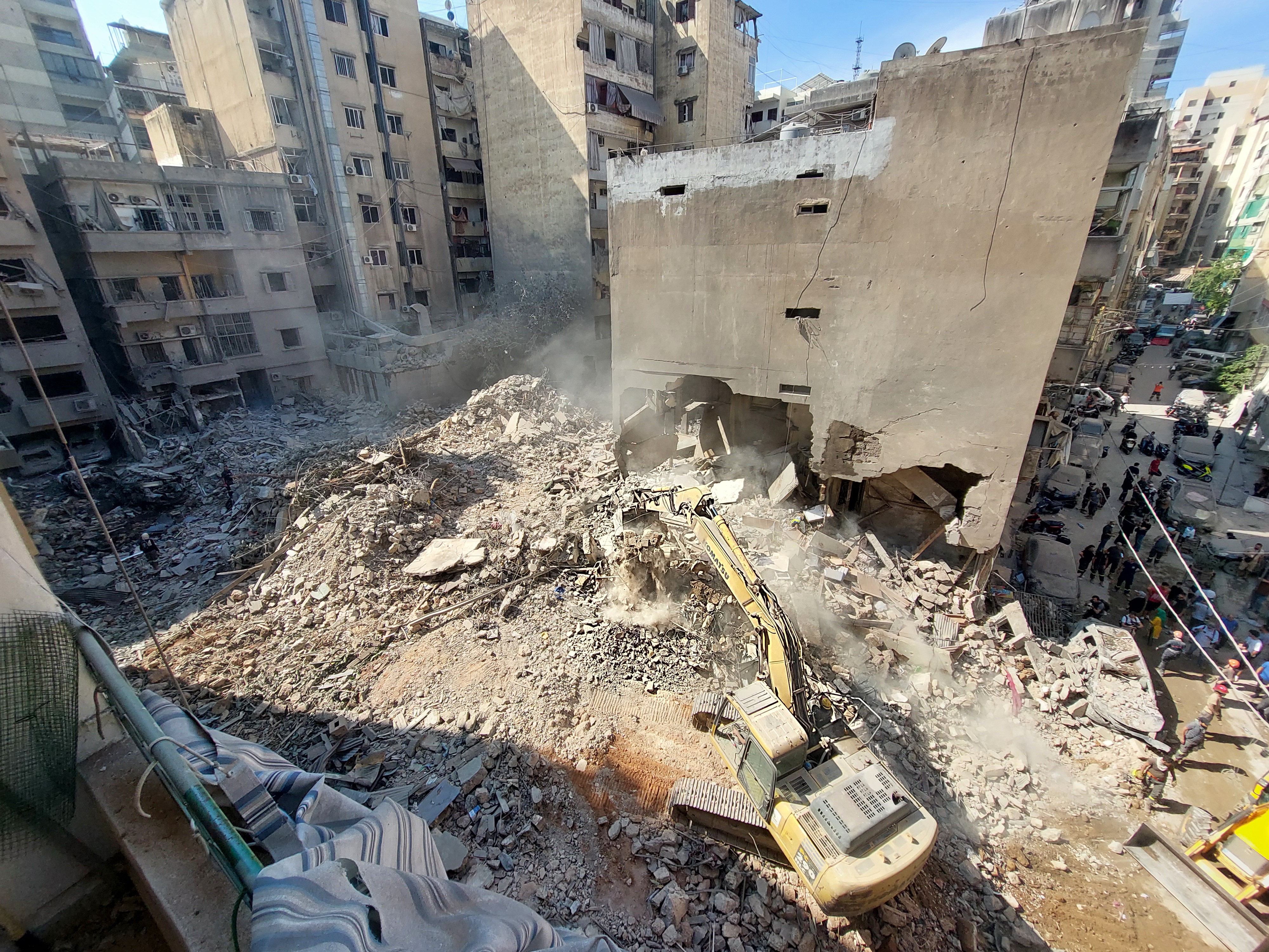 A scene in central Beirut, captured on October 11. A digger clears a mountain of rubble following an airstrike