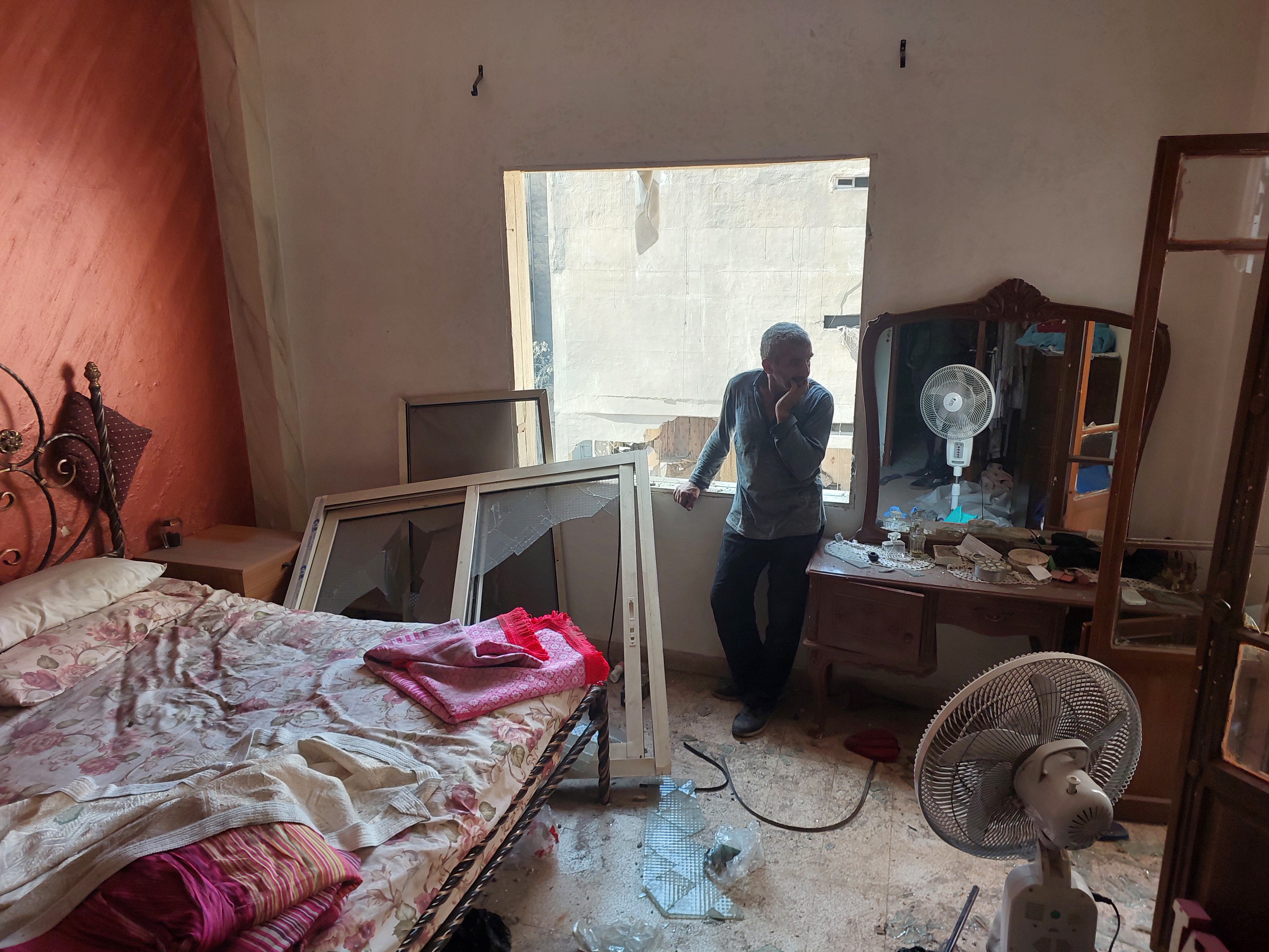 A man surveys his wrecked flat in central Beirut, following an Israeli airstrike