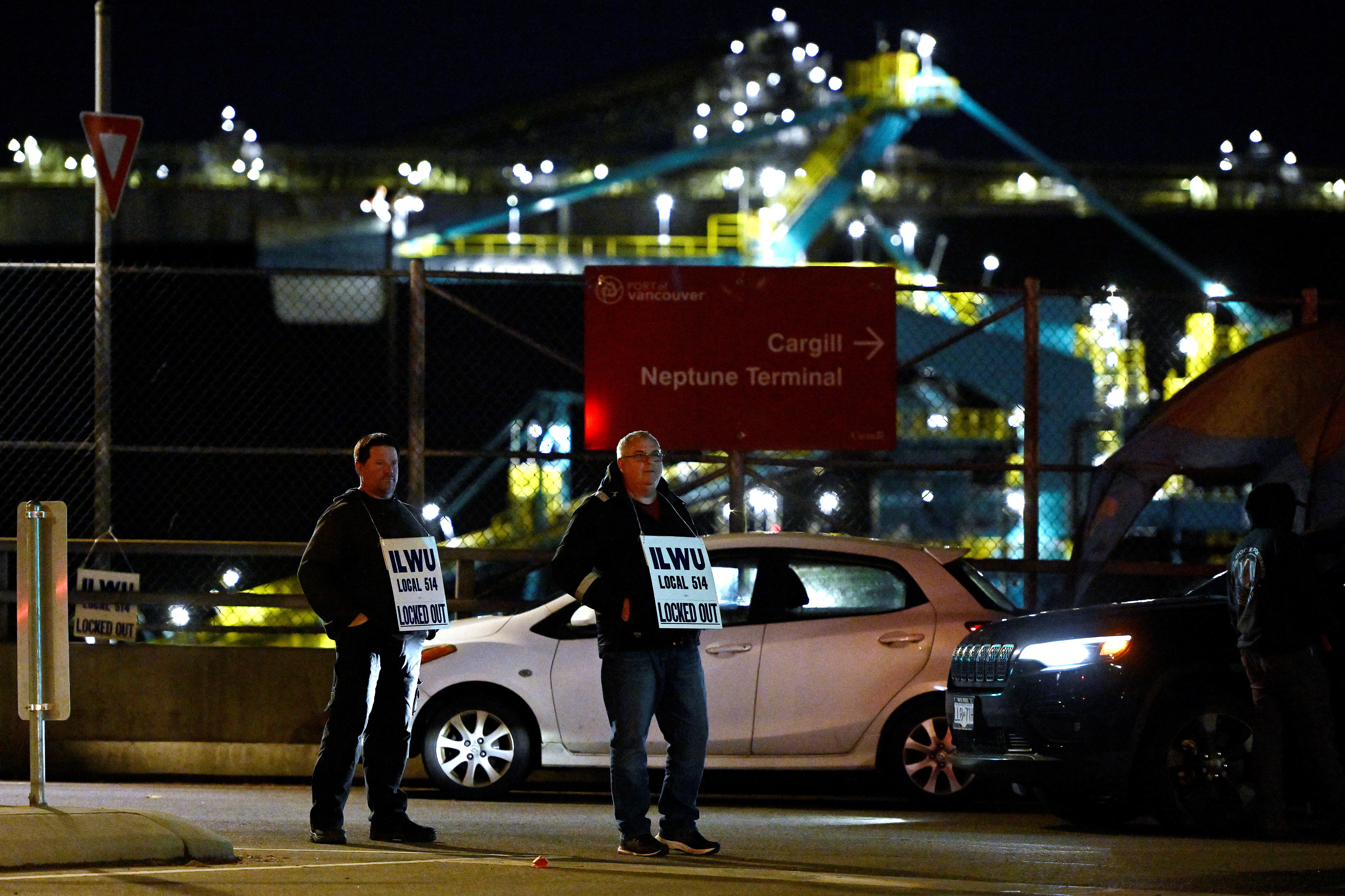 Workers picket outside of Neptune Terminals after a negotiating deadline passed and strike notice was not withdrawn in North Vancouver, British Columbia, Canada