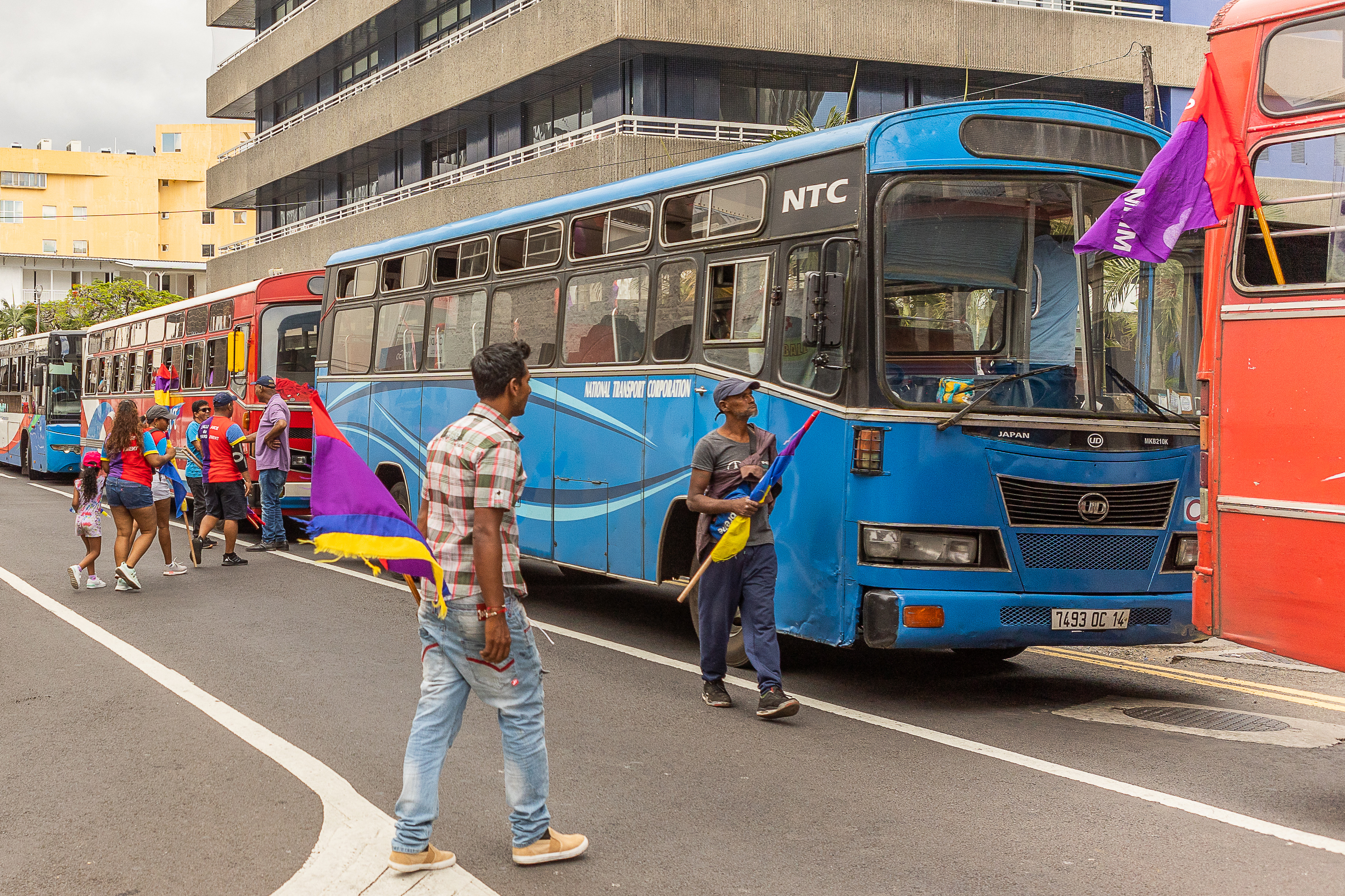 Supporters of Alliance du Changement arrive by bus to attend a campaign rally led by former Mauritius prime minister and candidate, Navin Ramgoolam, in Port Louis on November 3, 2024, ahead of the 2024 Mauritian general election