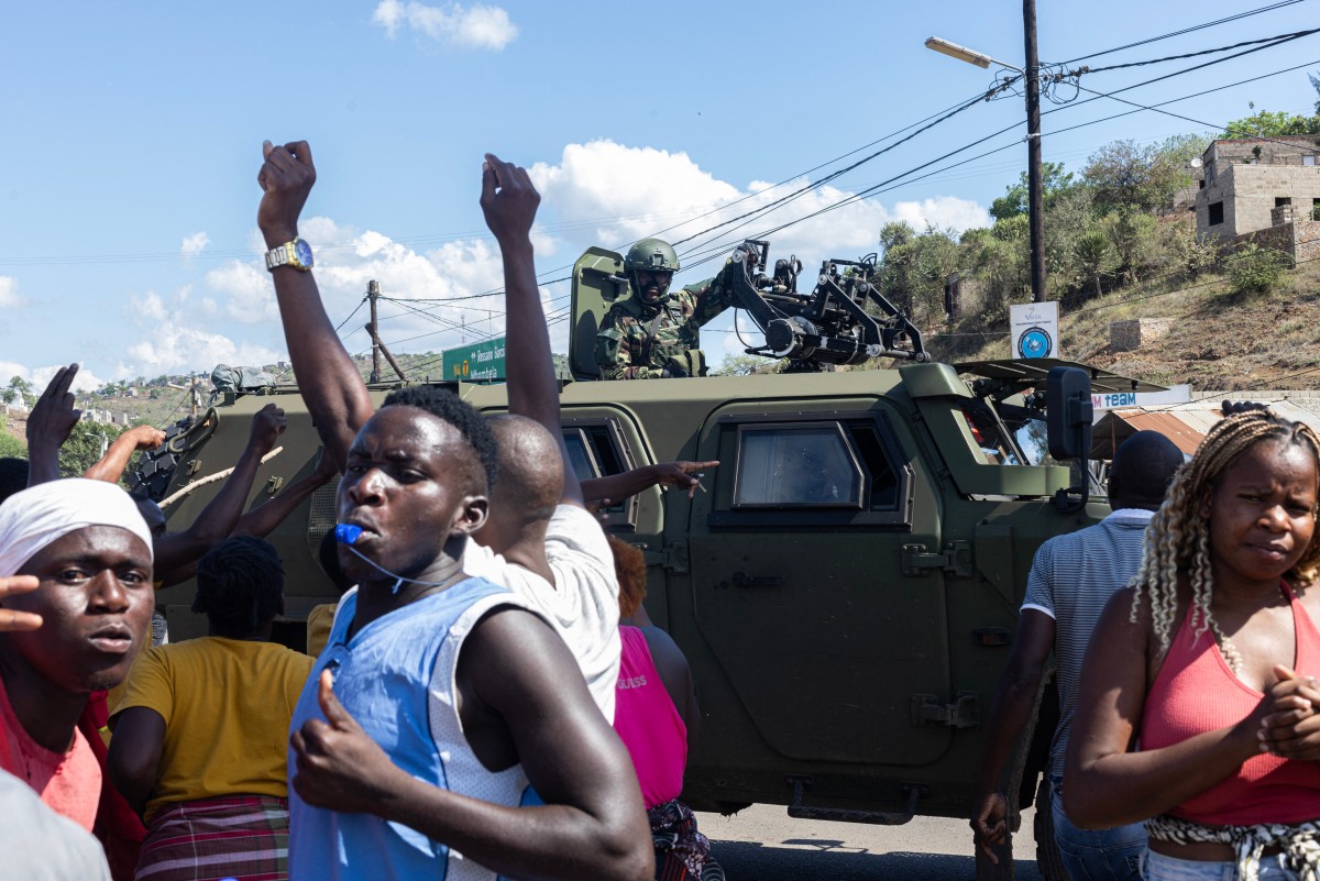 A military armoured vehicle blocks the road as protesters try to make their way to the Ressano Garcia border post between Mozambique and South Africa on November 13, 2024