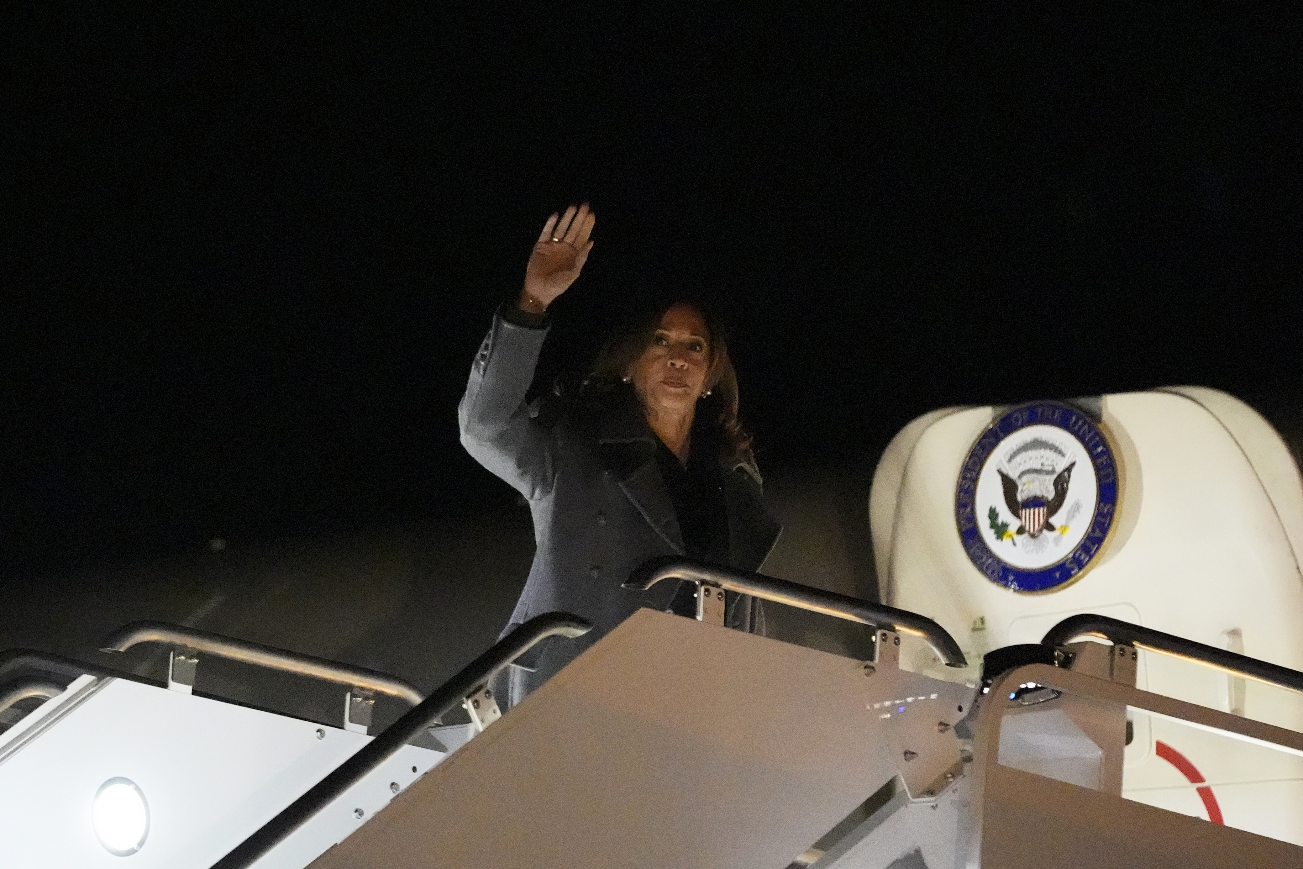 Vice President Kamala Harris waves as she boards Air Force Two in Green Bay, Wisconsin, on November 1