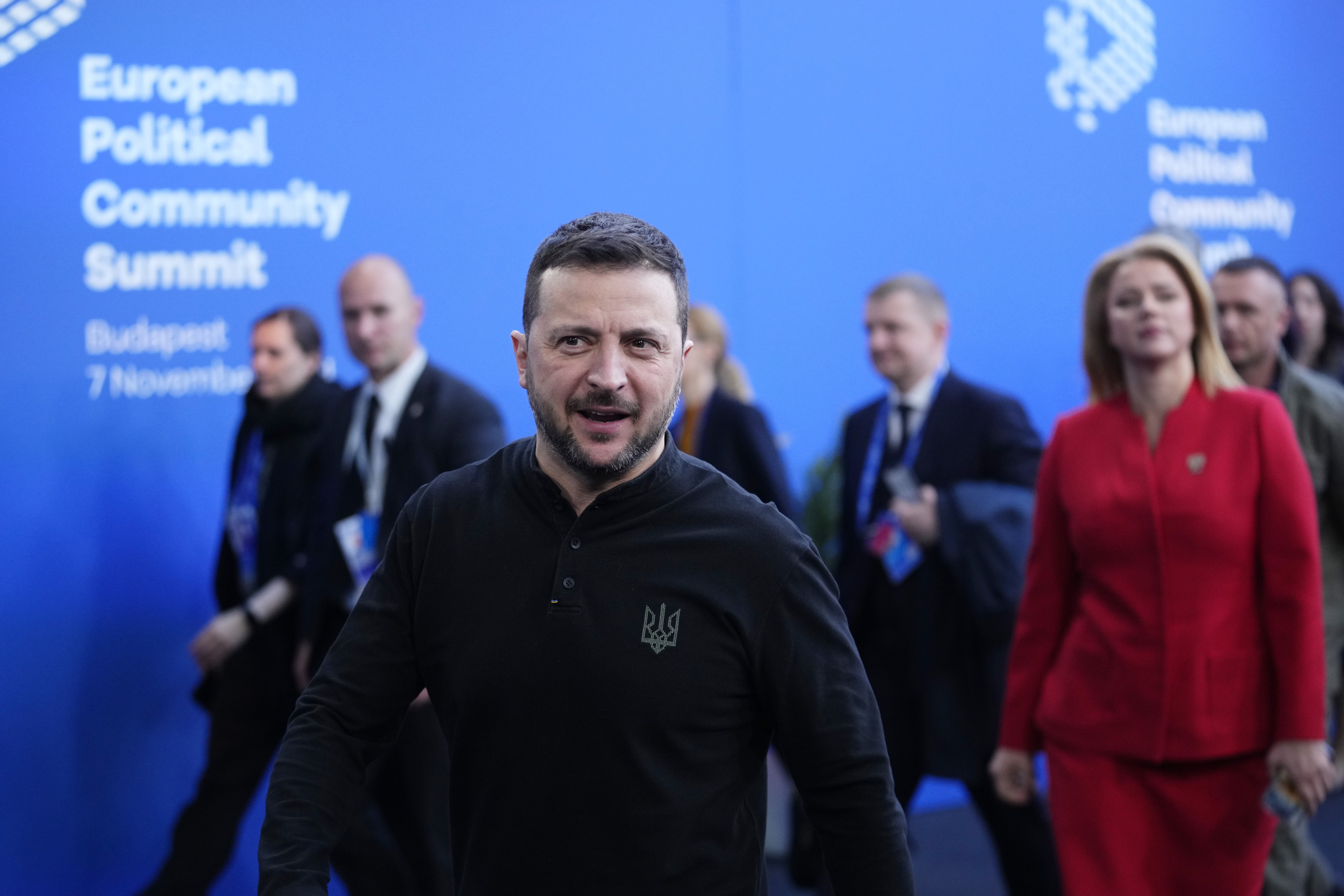 Ukraine’s President Volodymyr Zelenskyy, centre and Latvia Prime Minister Evika Silina, right, arrive for the European Political Community Summit at the Puskas Arena in Budapest, Hungary