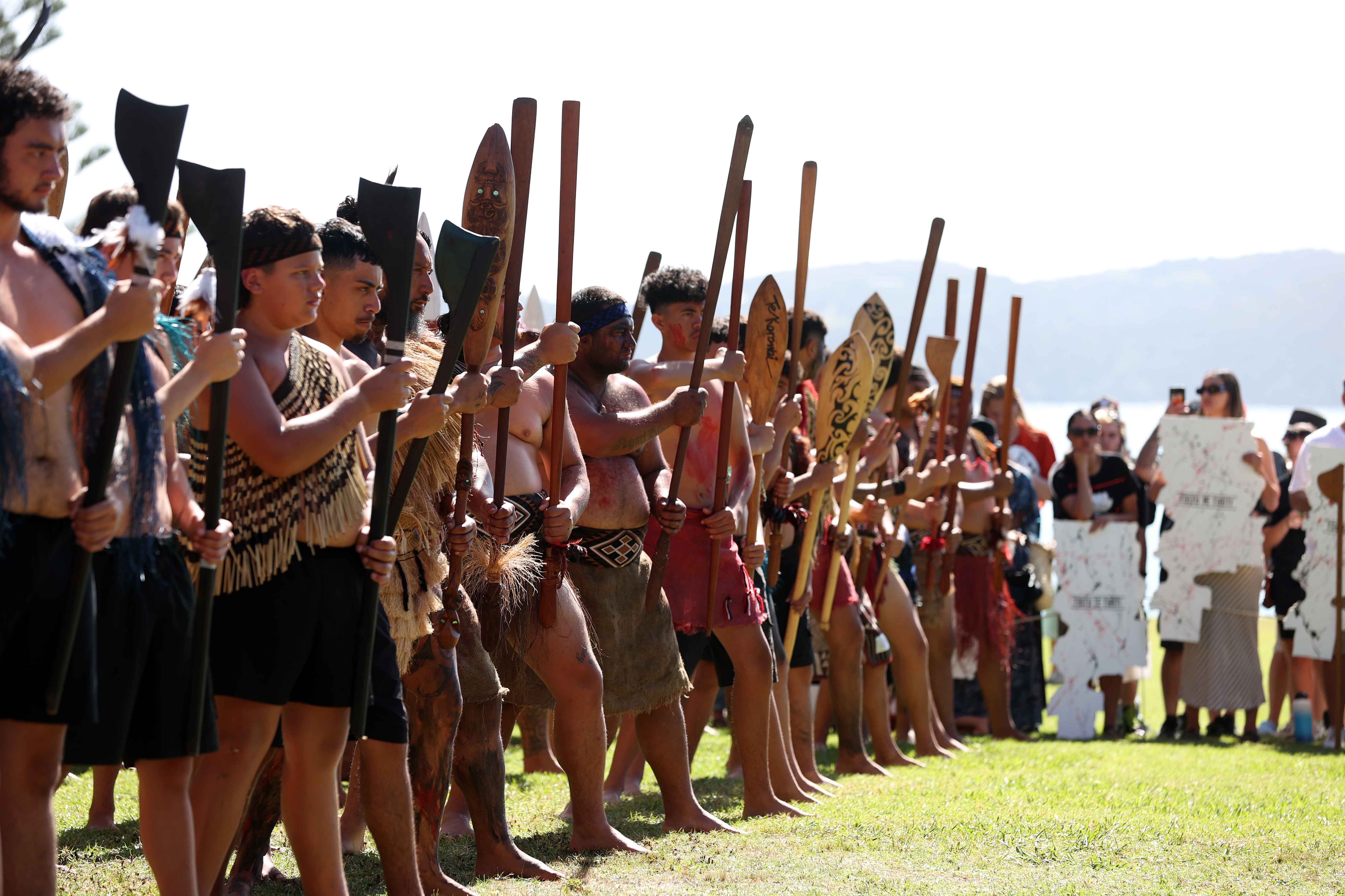 Maori warriors prepare to greet New Zealand government representatives including Prime Minister Christopher Luxon at Te Whare Runanga during a powhiri (welcoming ceremony) on February 5, 2024 in Waitangi, New Zealand. The Waitangi Day national holiday celebrates the signing of the treaty of Waitangi on February 6, 1840 by Maori chiefs and the British Crown