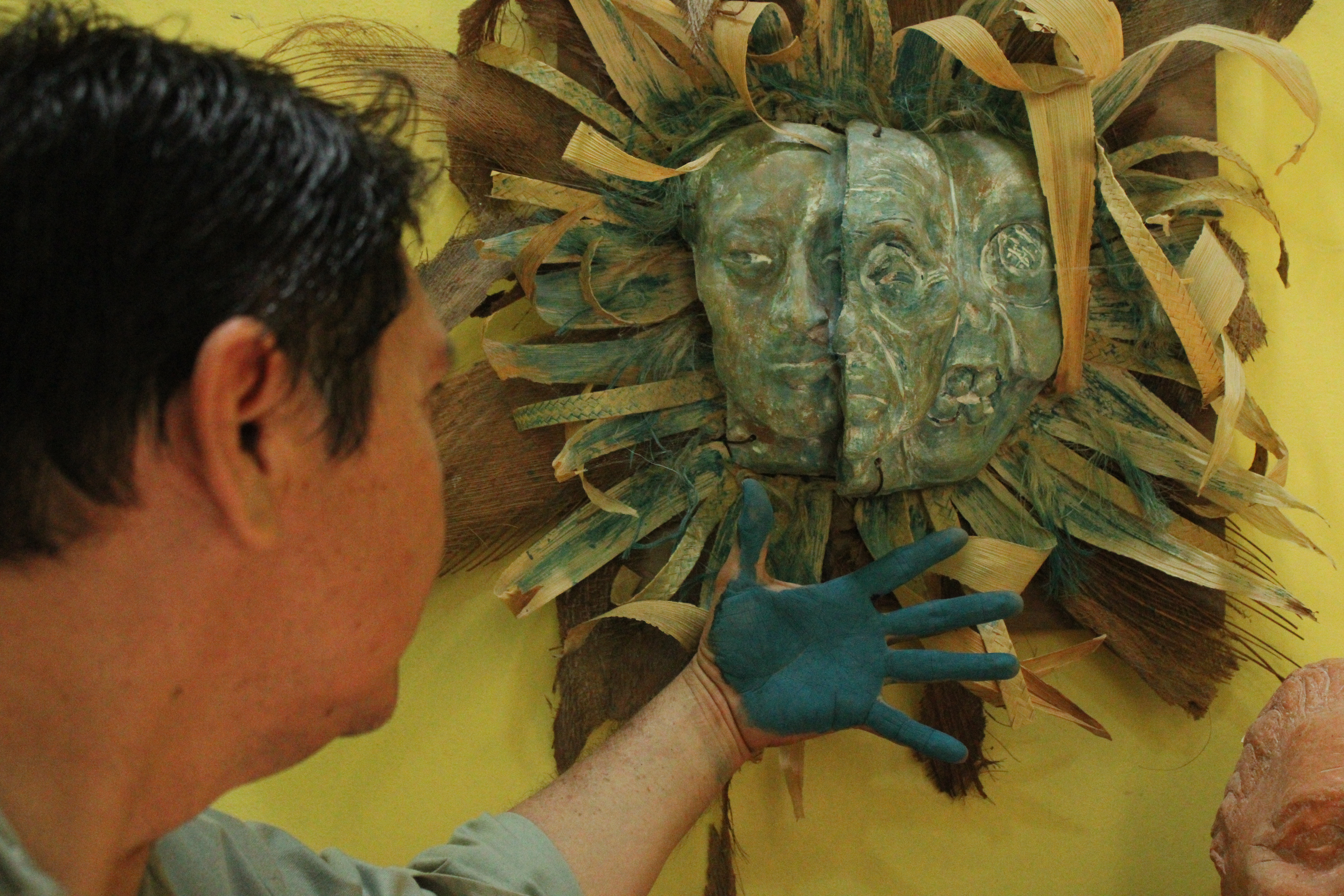 Luis May Ku, 49, admires a three-sided facemask he sculptured, adorned with dried palm leaves and painted in Maya Blue inside his home in Dzan, Yucatán, Mexico, on 9 September, 2024_-1731947746
