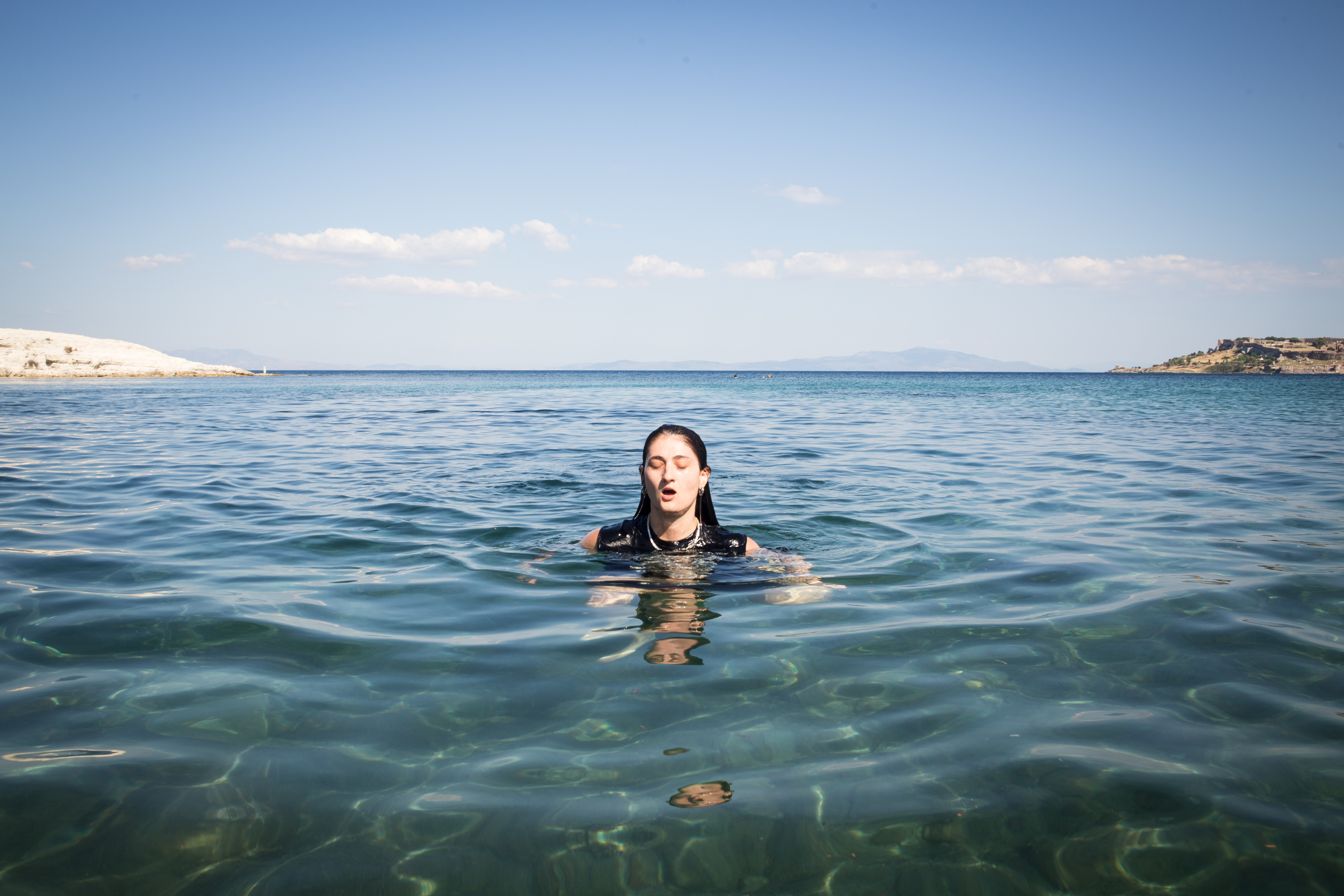 Renia Voyatzi, a volunteer coordinator, gets out of the water at the end of a swimming session. [Giacomo Sini/Al Jazeera]