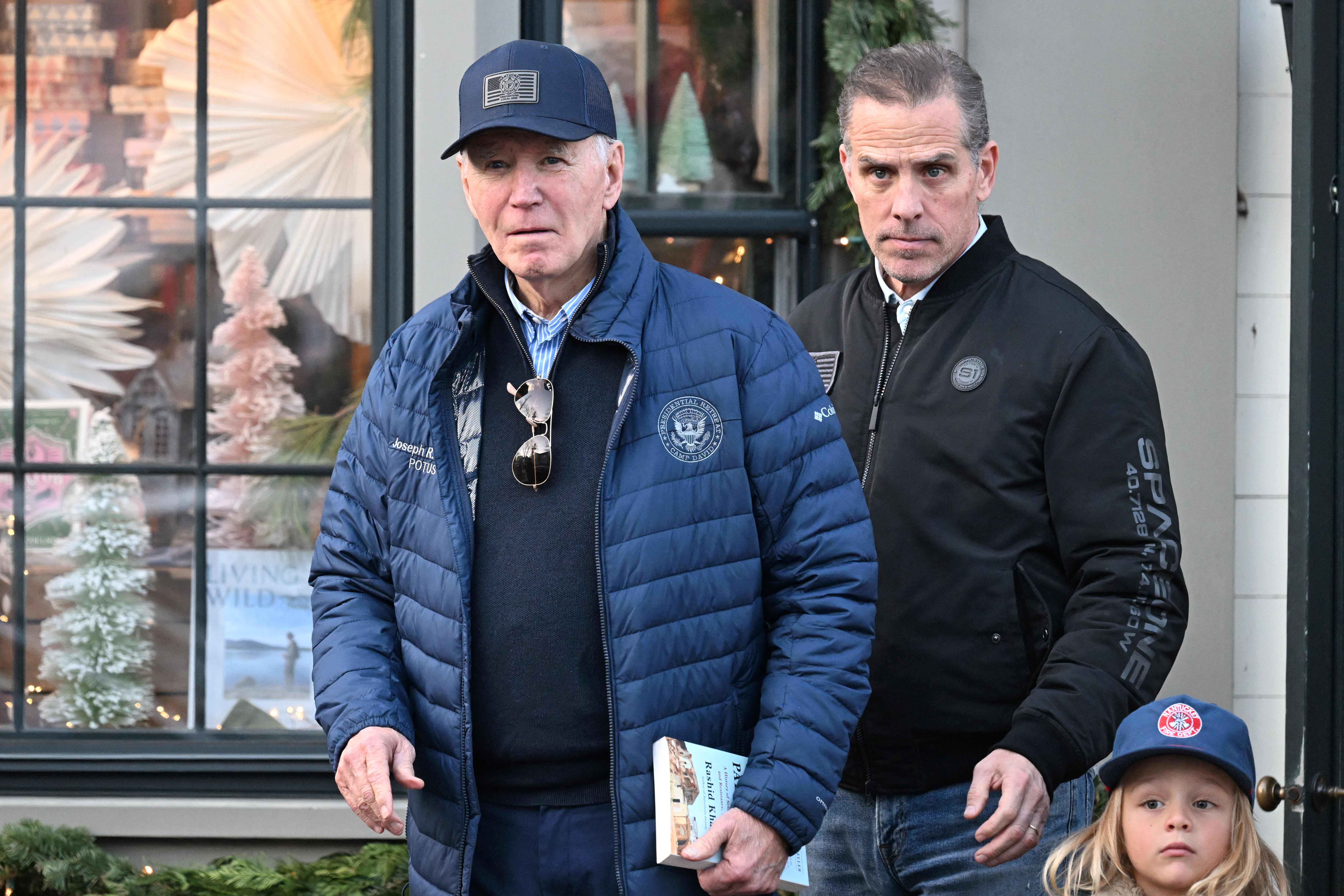 President Joe Biden, left, is accompanied by Hunter Biden, centre, and Beau Biden Jr in downtown Nantucket, Massachusetts, on November 29, 2024