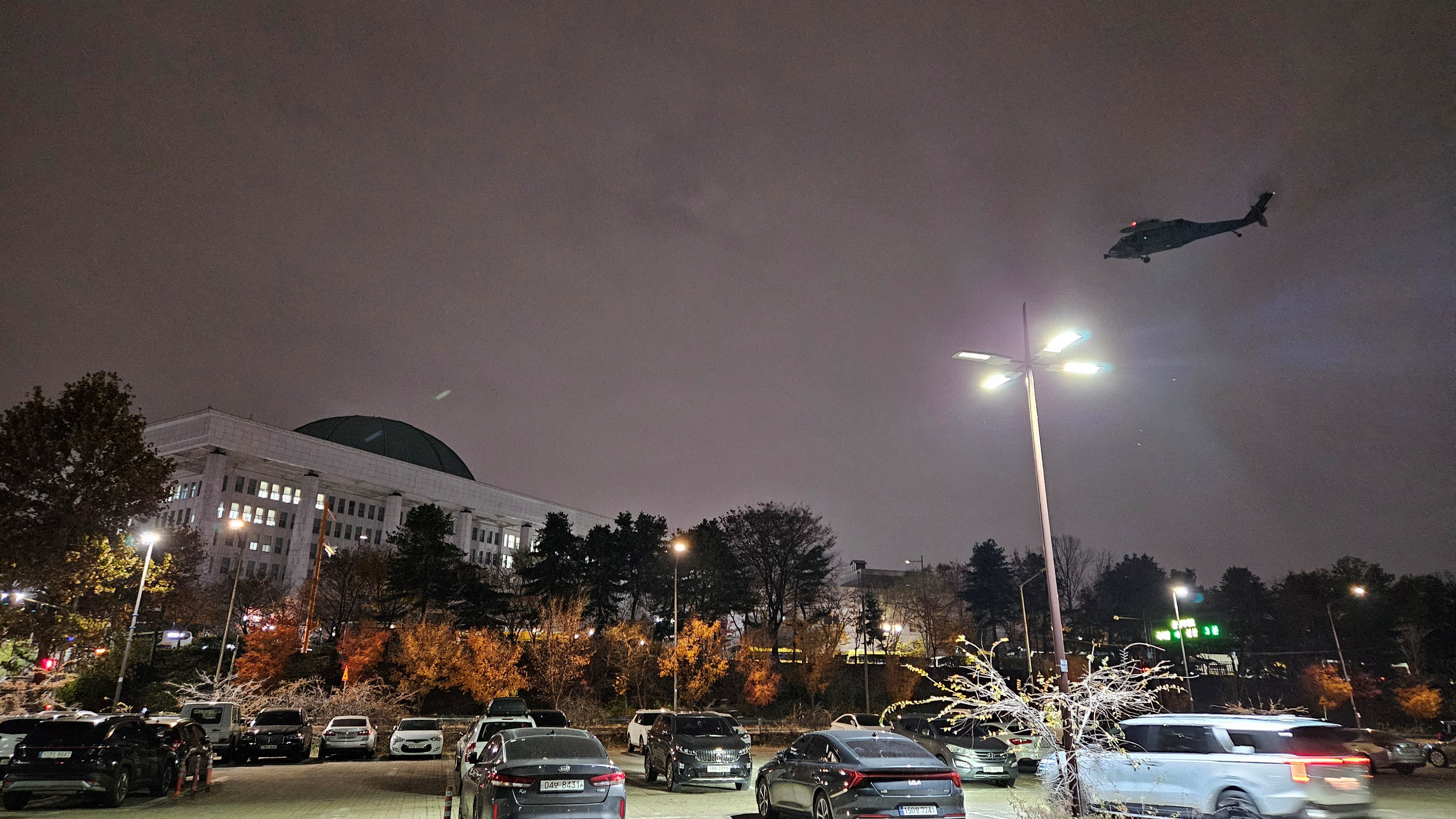 A military helicopter flies around the National Assembly in Seoul after South Korean President Yoon Suk-yeol declared martial law on December 3, 2024 [Yonhap via Reuters]