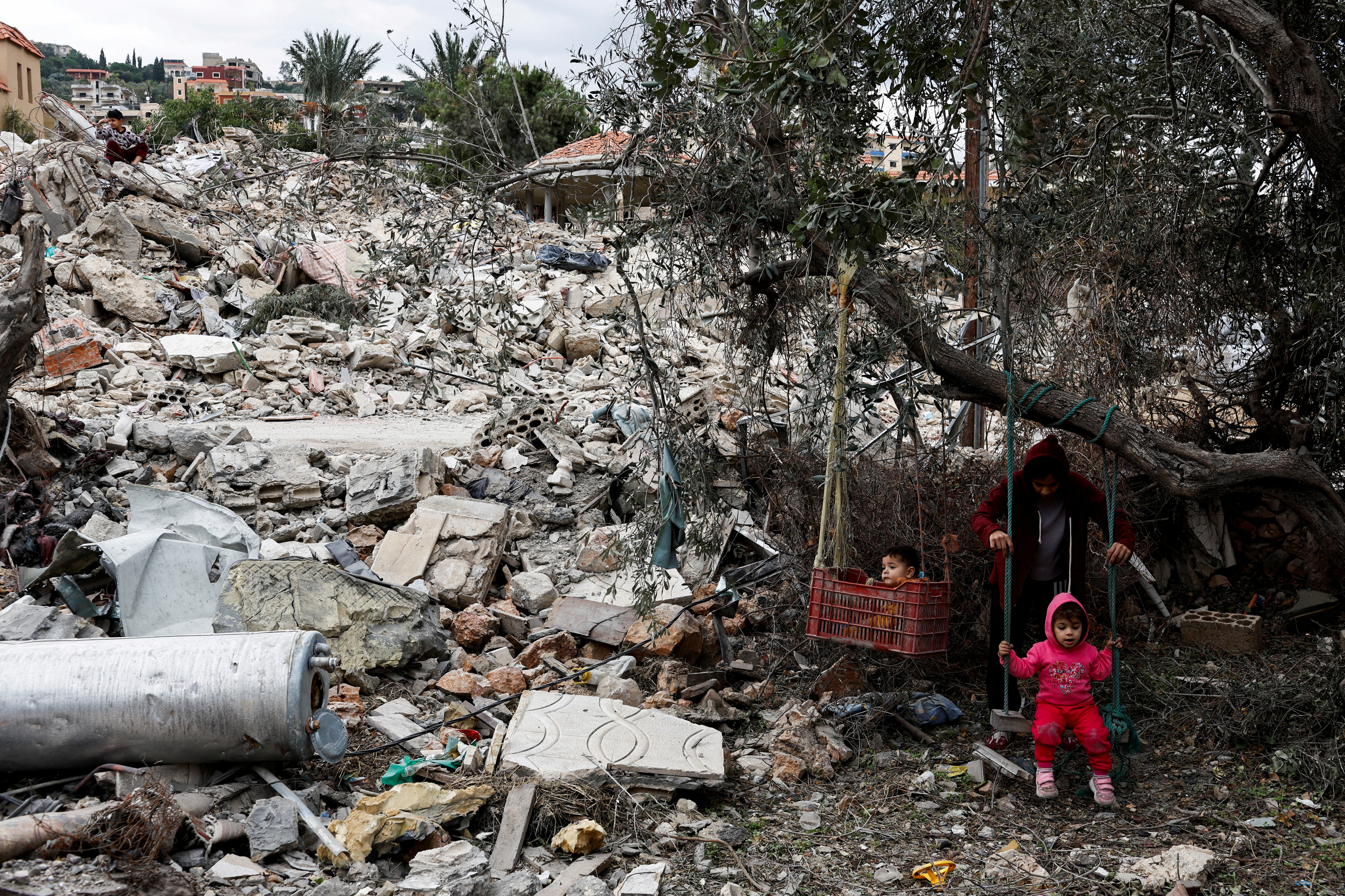 Children play amidst the rubble of their house that was destroyed in the village of Mansouriyeh, after the ceasefire agreement between Israel and Hezbollah took effect, southern Lebanon December 4, 2024. REUTERS/Thaier Al-Sudani TPX IMAGES OF THE DAY