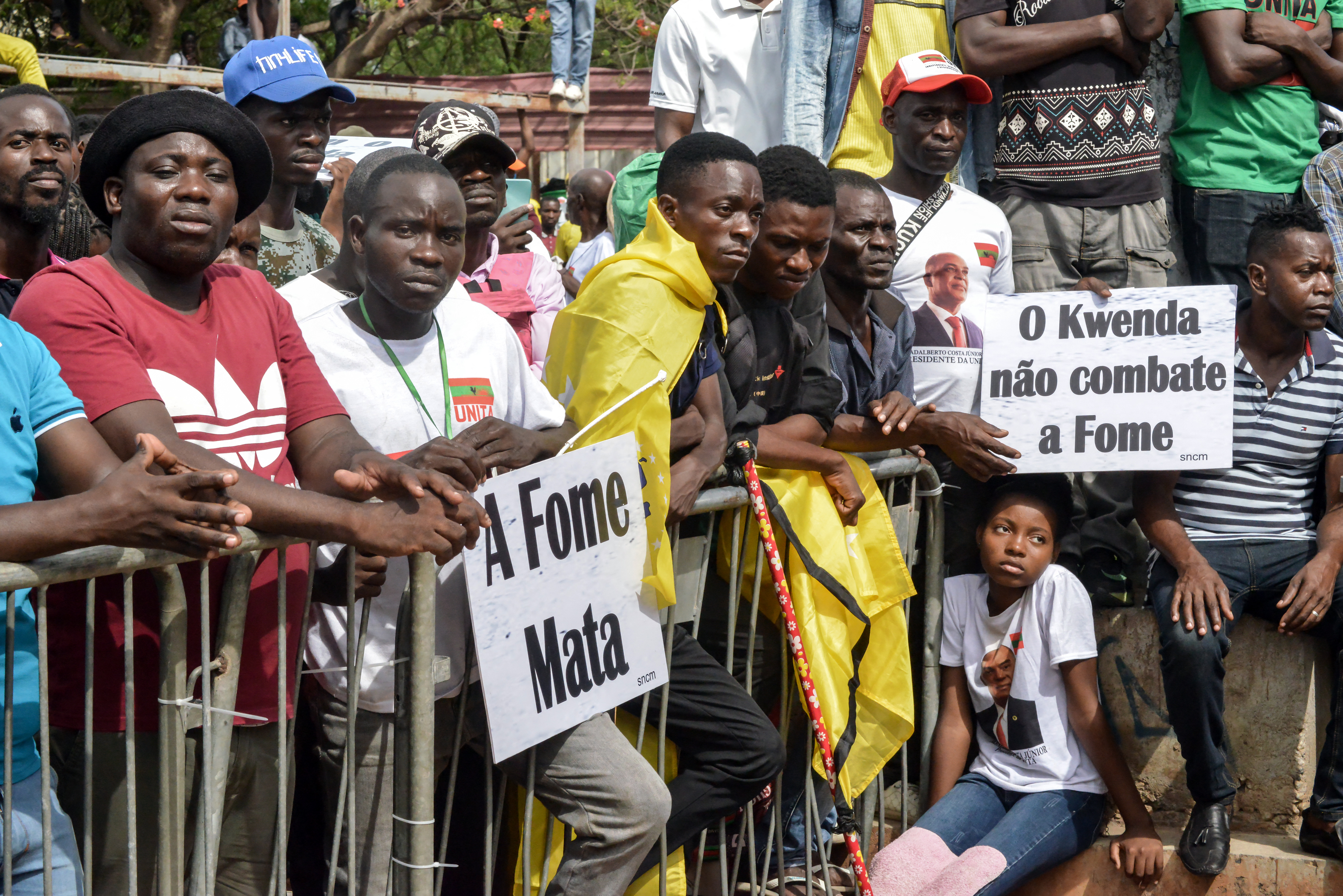 Supporters of the National Union for the Total Independence of Angola (UNITA) and other opposition groups hold banners as they gather following a march to protest against Angola’s governing party and President Joao Lourenco in Luanda, on November 23, 2024