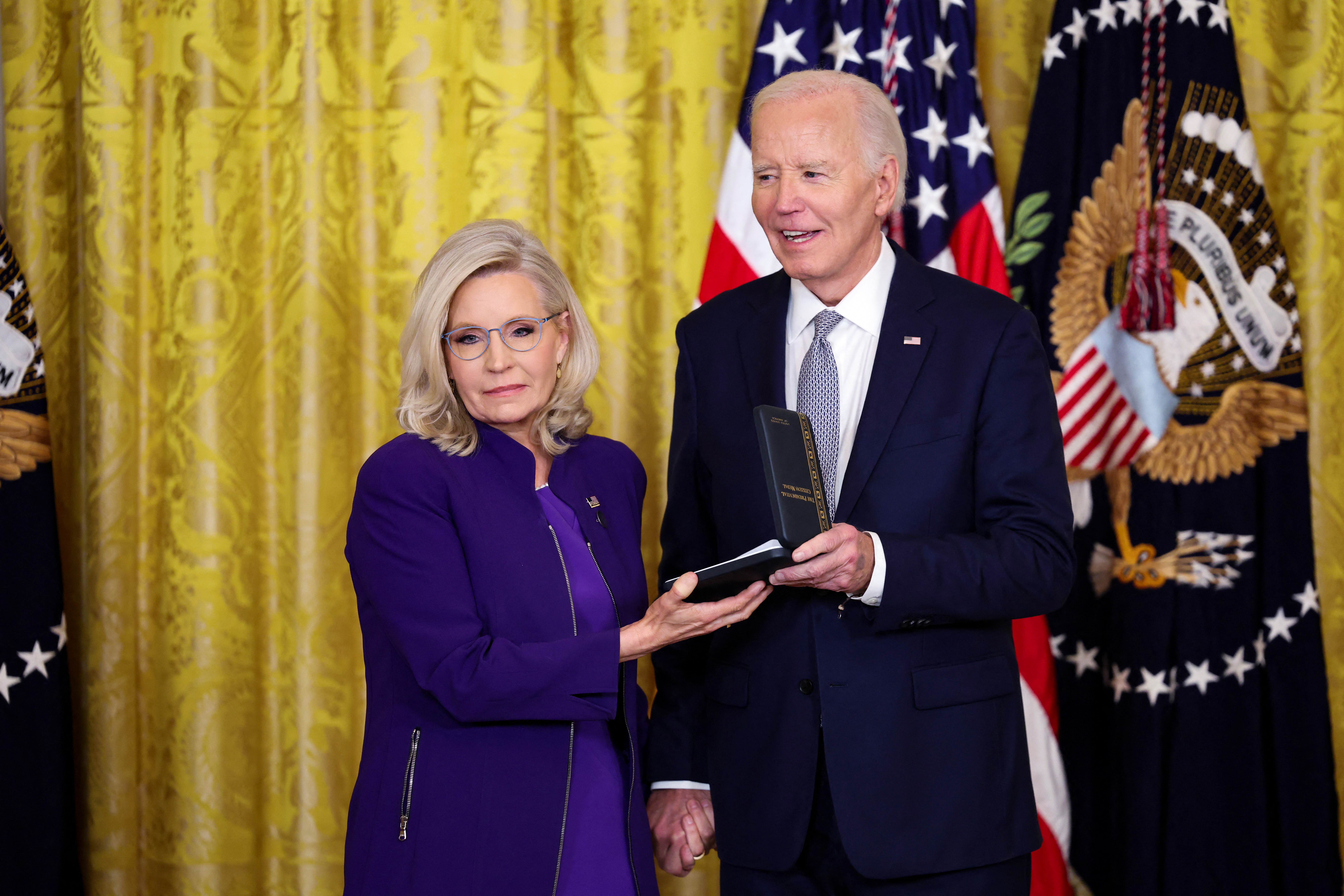 US President Joe Biden hands Liz Cheney the Presidential Citizens Medal on January 2