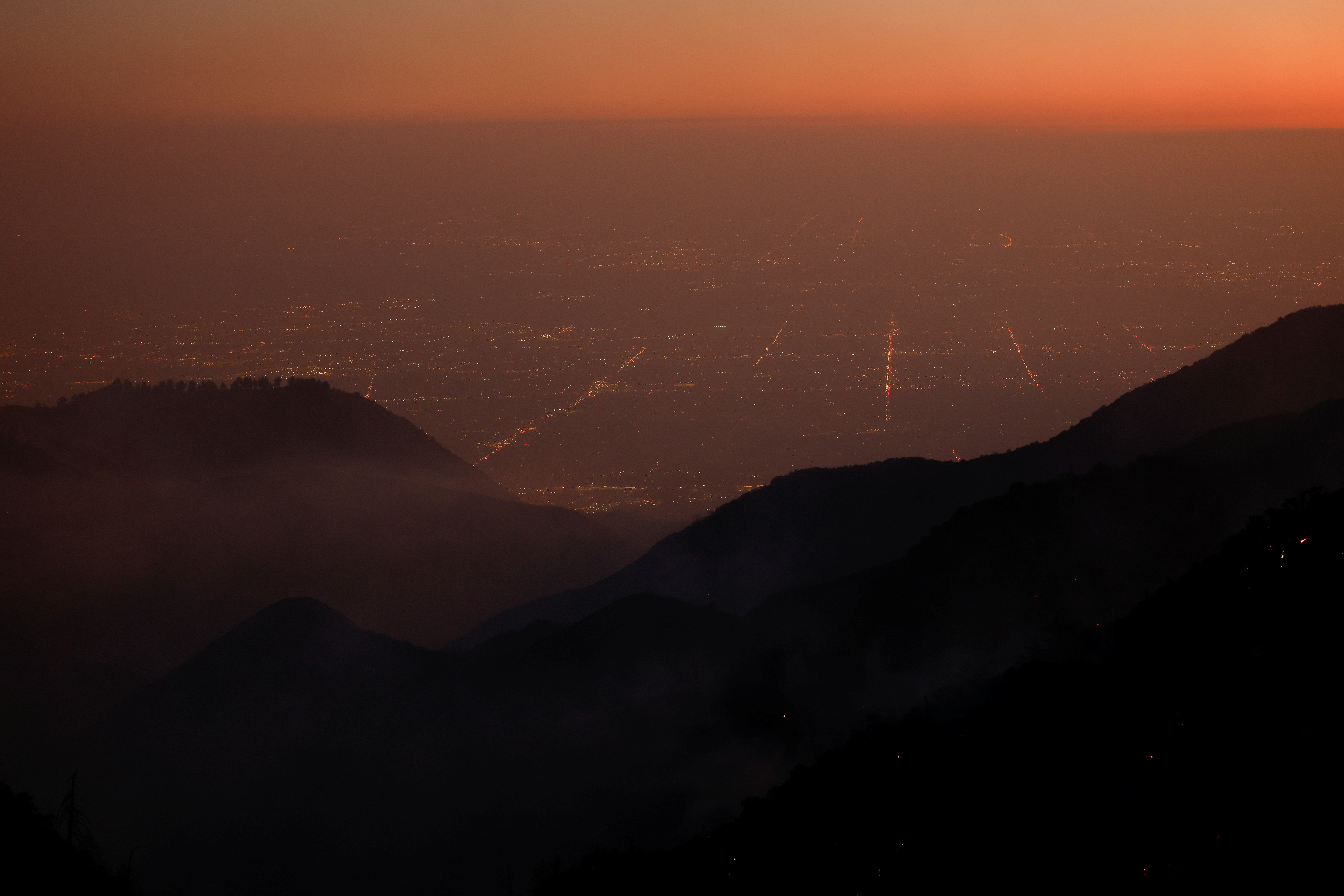 Smoke rises over the hillside near Mount Wilson during the Eaton Fire, above LA County, as wildfires burn in the Los Angeles area, California, U.S., January 10, 2025.