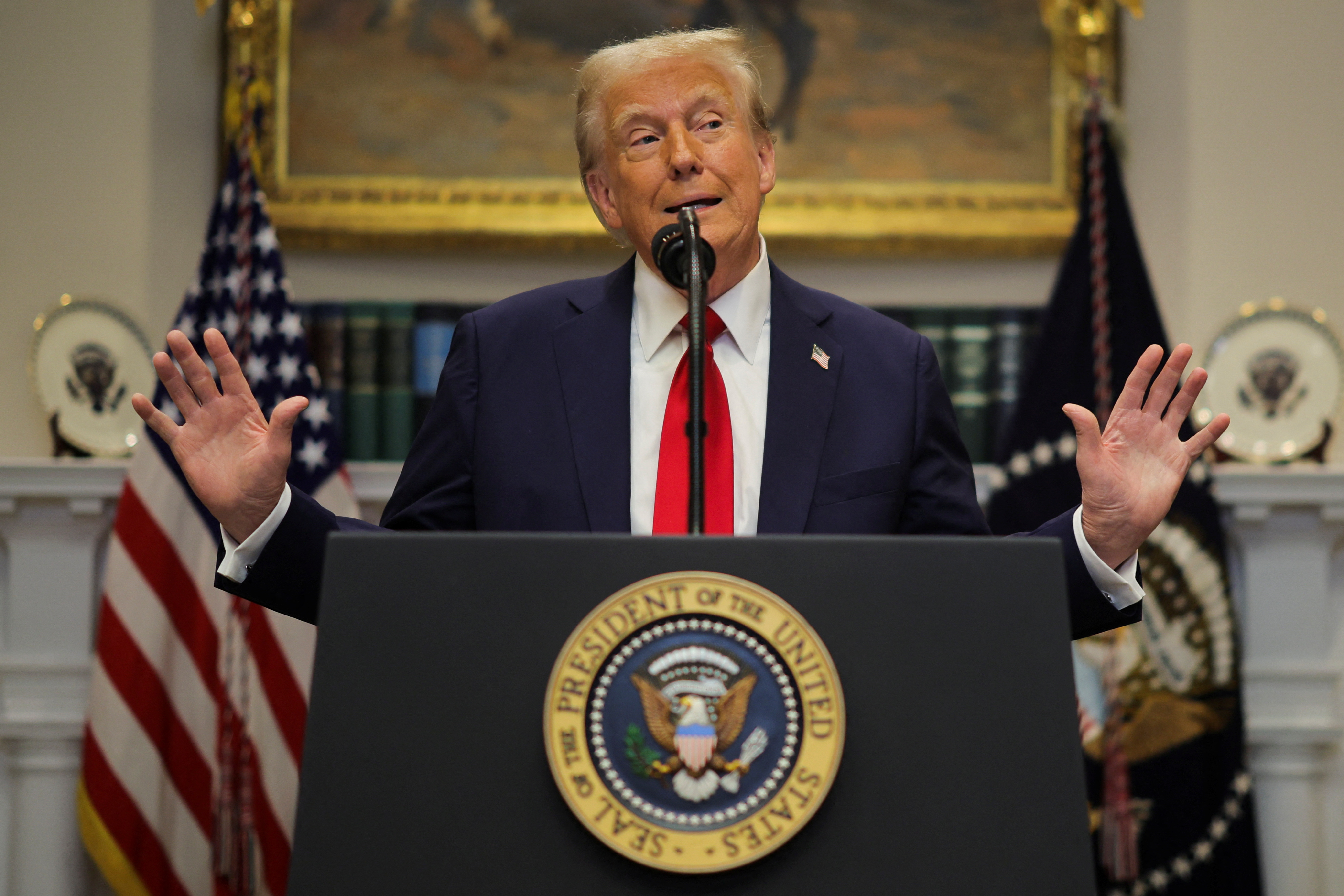 Donald Trump at a podium in the White House.