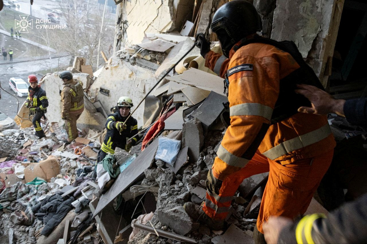 Rescuers work at a site of an apartment building damaged in a Russian drone strike