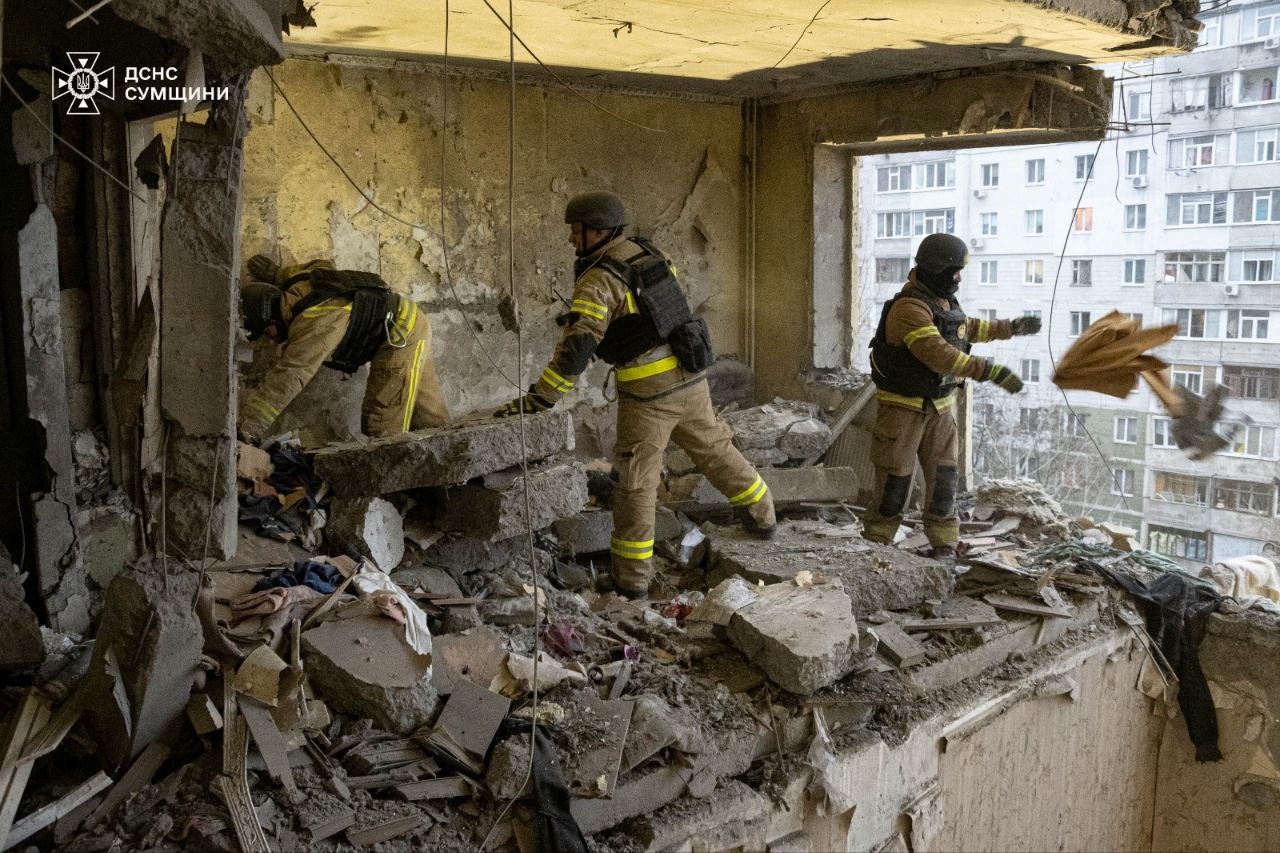 Rescuers work at a site of an apartment building damaged in a Russian drone attack in Sumy, Ukraine