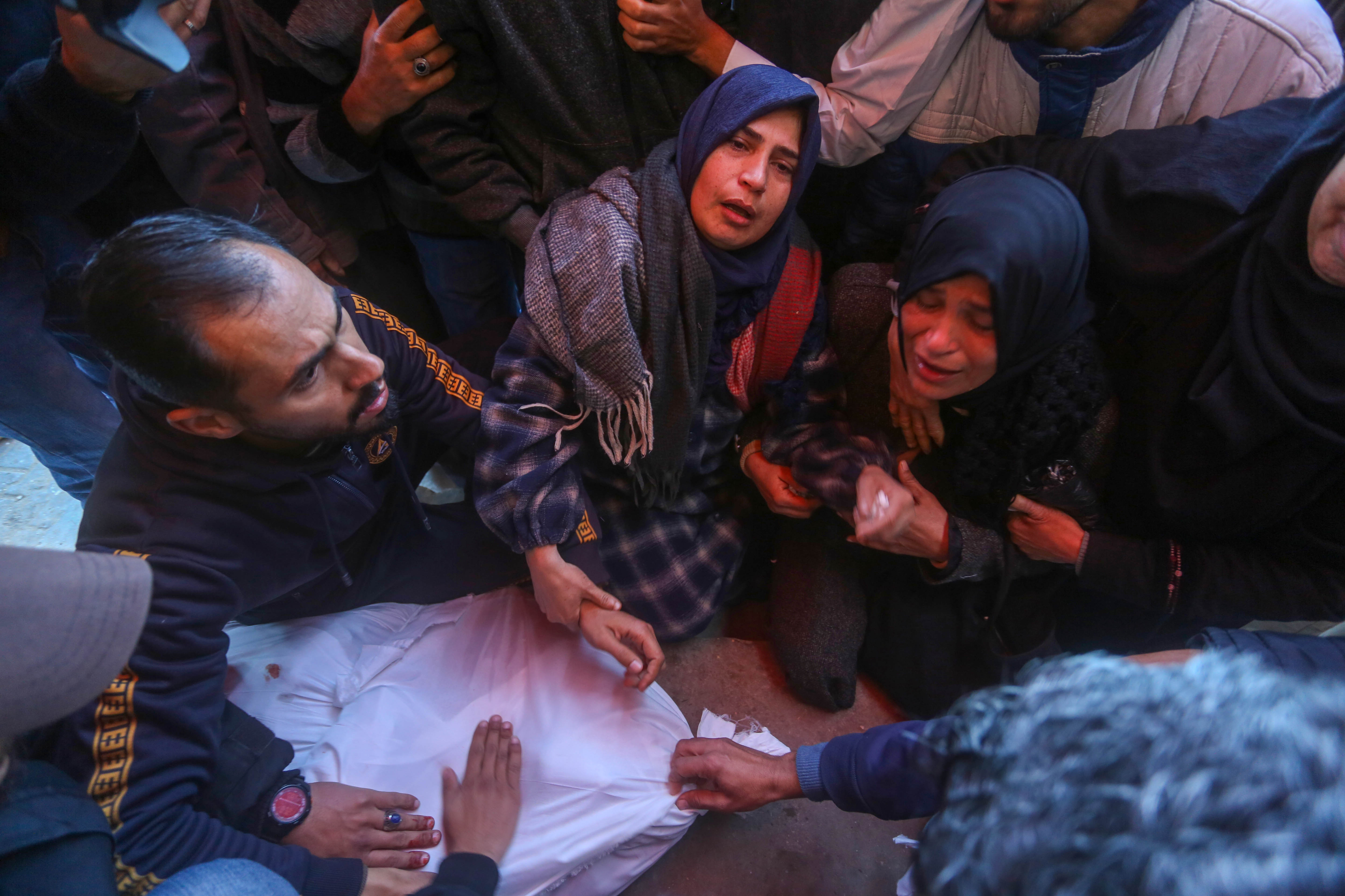 Relatives of the Palestinians killed in an Israeli attack mourn their loss as bodies are brought to Al-Aqsa Martyrs Hospital for funeral prayer and burial, in Deir el-Balah, Gaza on January 12, 2025
