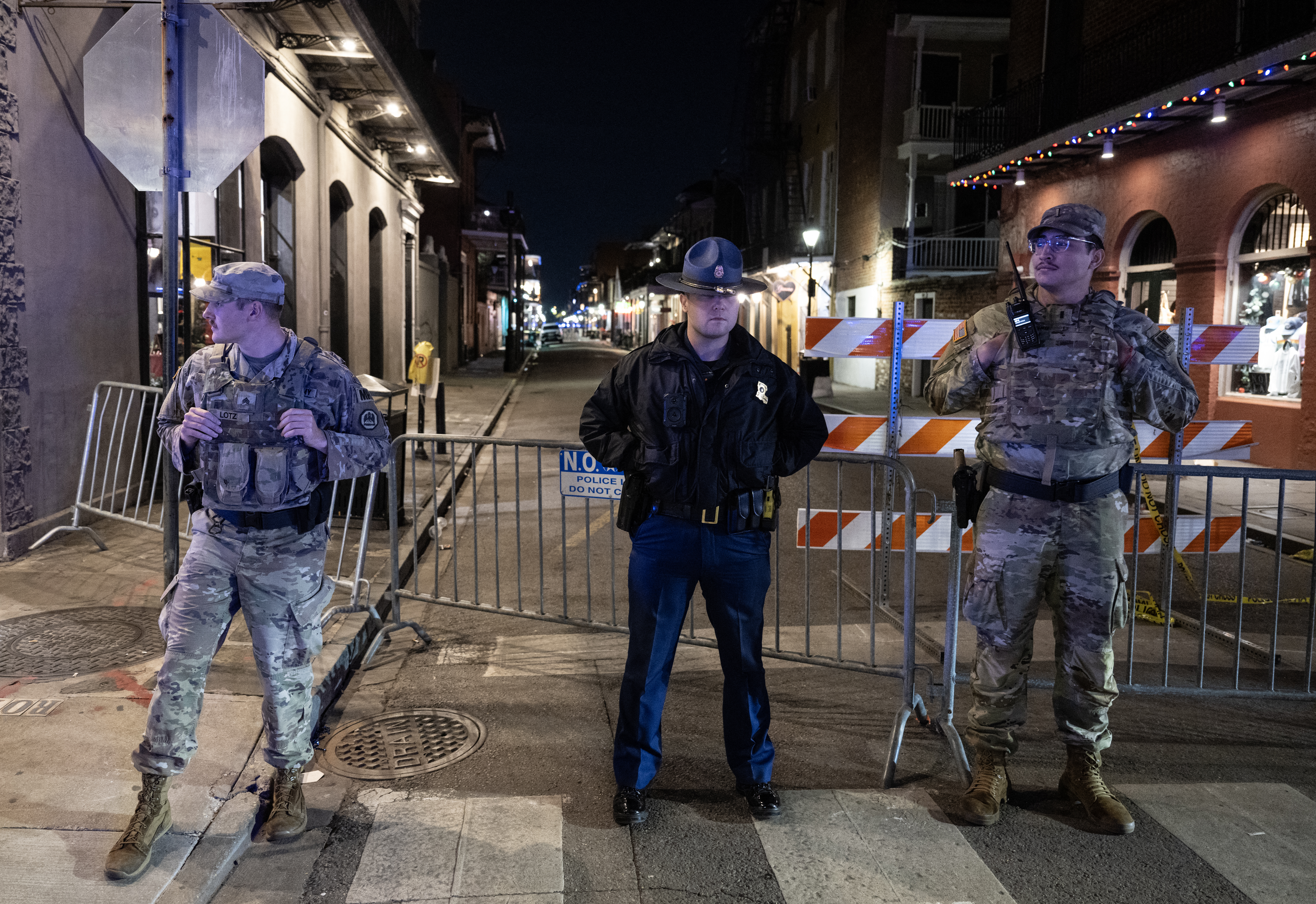 Members of the National Guard and police look on at a blocked off street in New Orleans