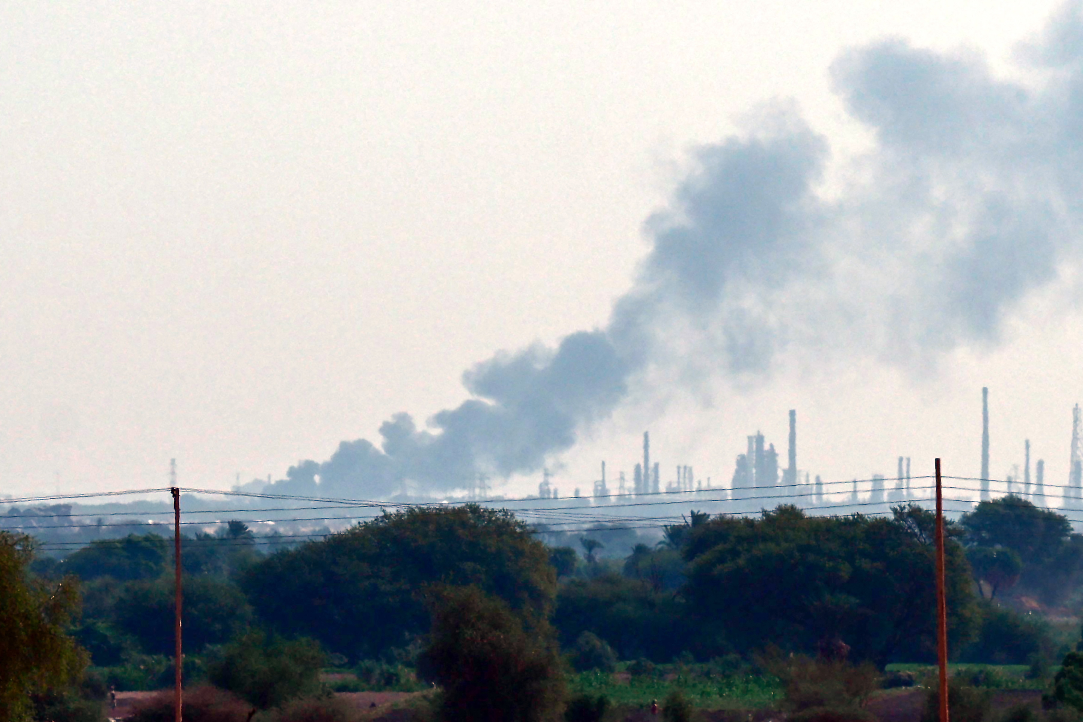 Smoke billows from al-Jili oil refinery.