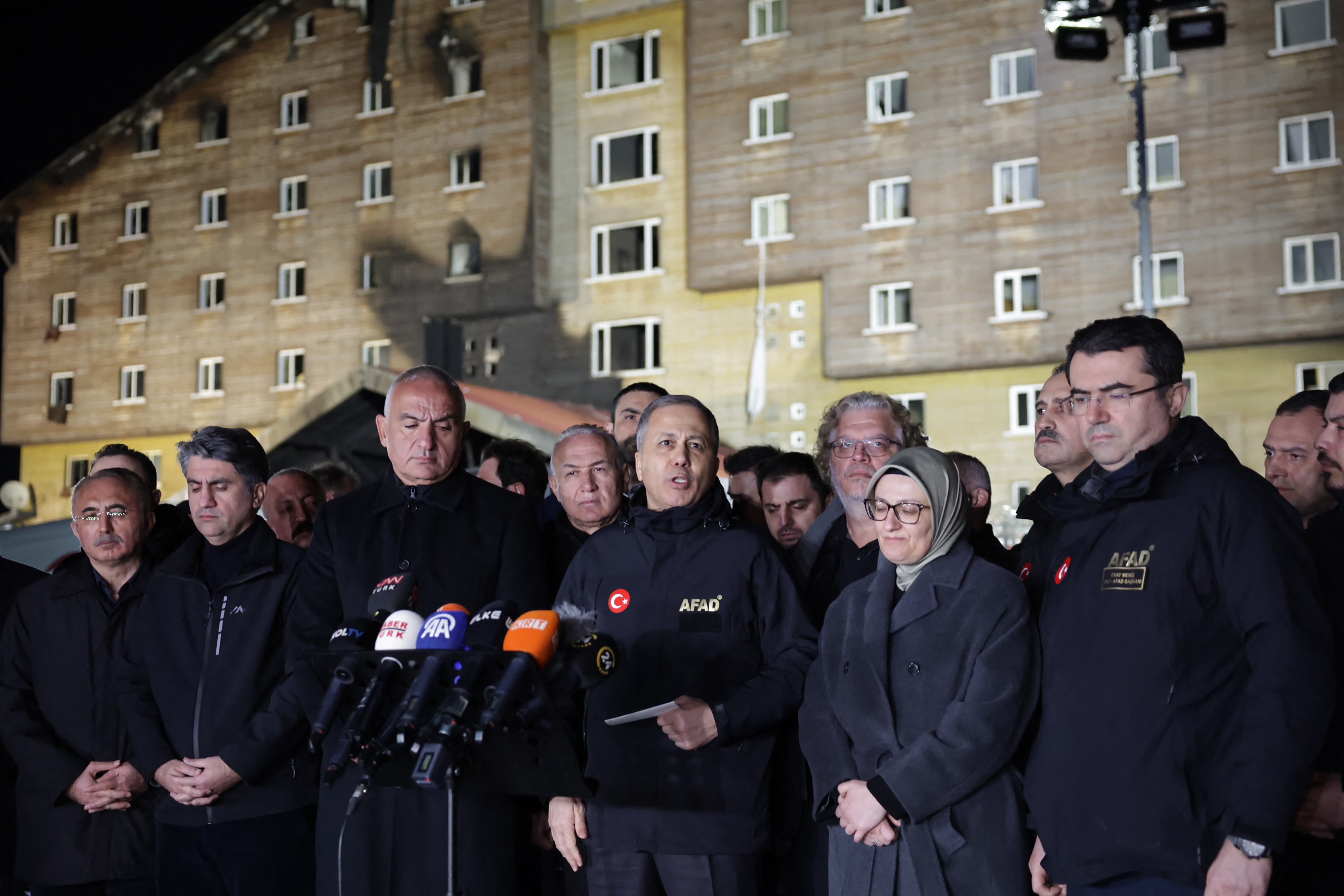 Turkish Interior Minister Ali Yerlikaya (C) addresses media outside the hotel where a fire broke out in the Kartalkaya ski resort in Bolu, Turkiye