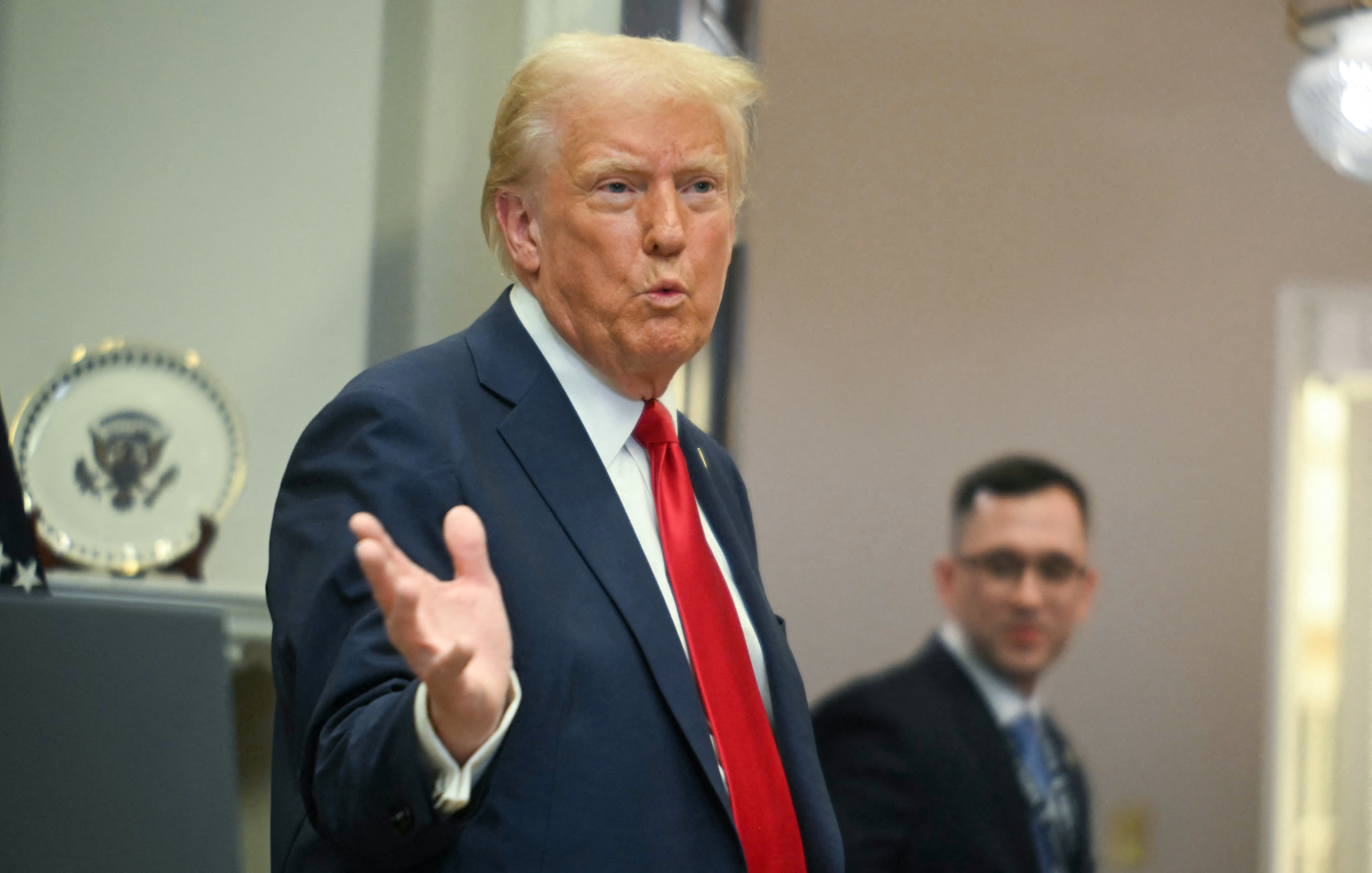 US President Donald Trump gestures as he leaves after speaking in the Roosevelt Room at the White House on January 21, 2025, in Washington, DC.
