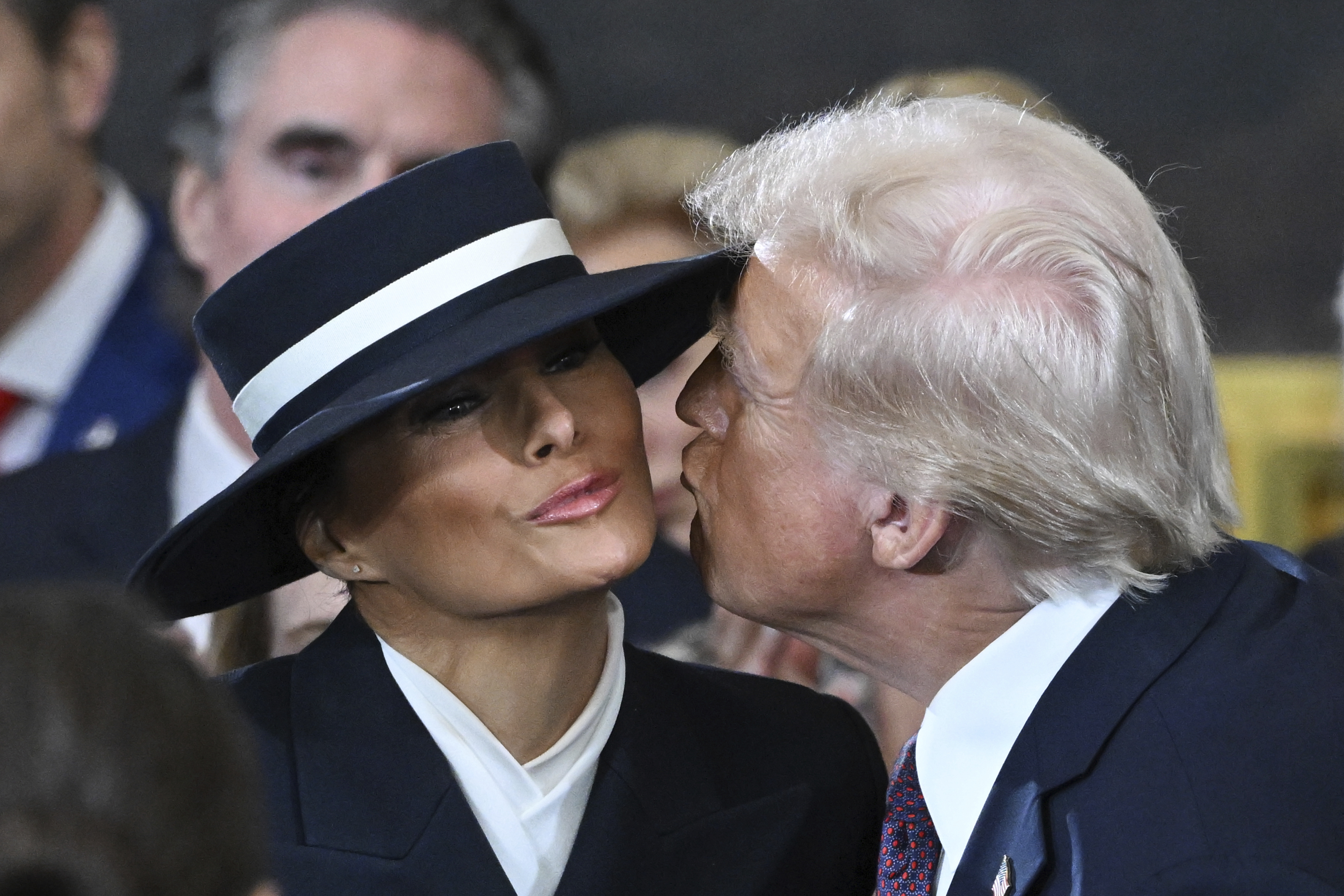 Donald Trump leans in to kiss Melania Trump on the cheek