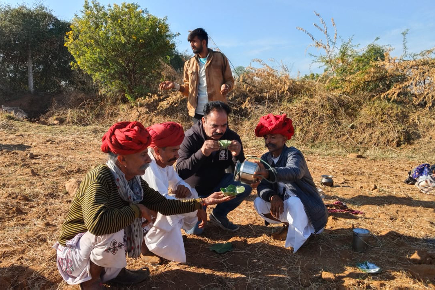 Sadri and breeders taste camel milk in a traditional way