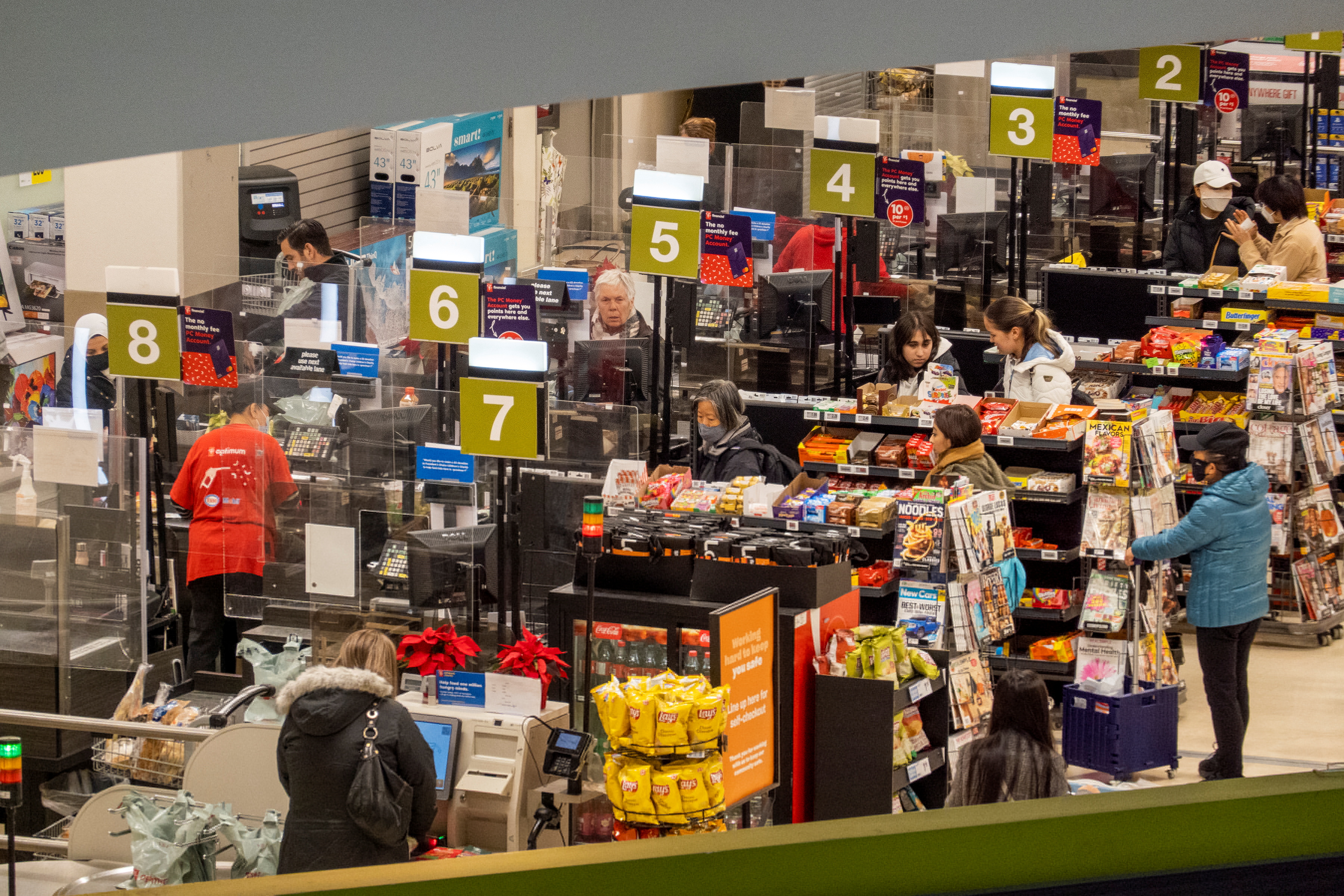 People pay for their items at a grocery store in Toronto, Canada