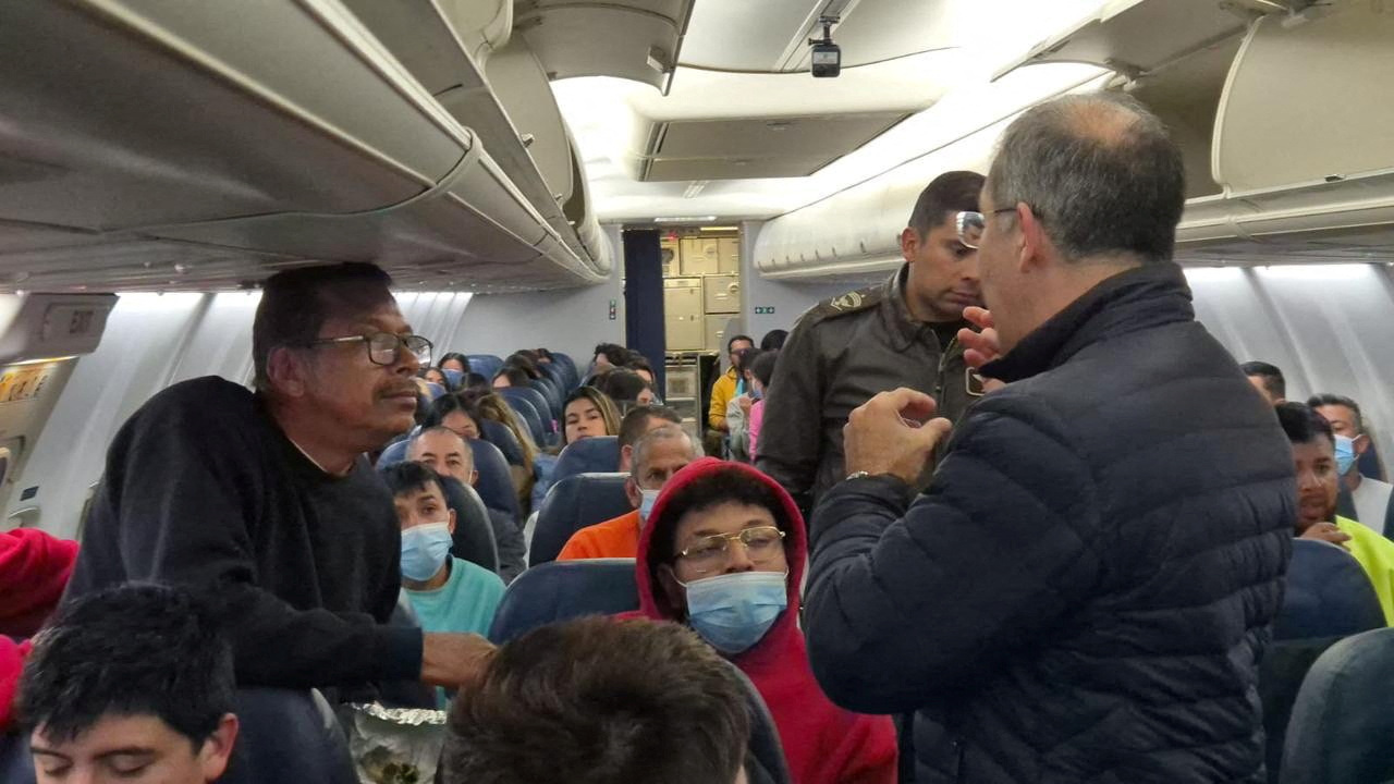 Colombian nationals sit inside a Colombian Air Force plane during a deportation flight from the US.