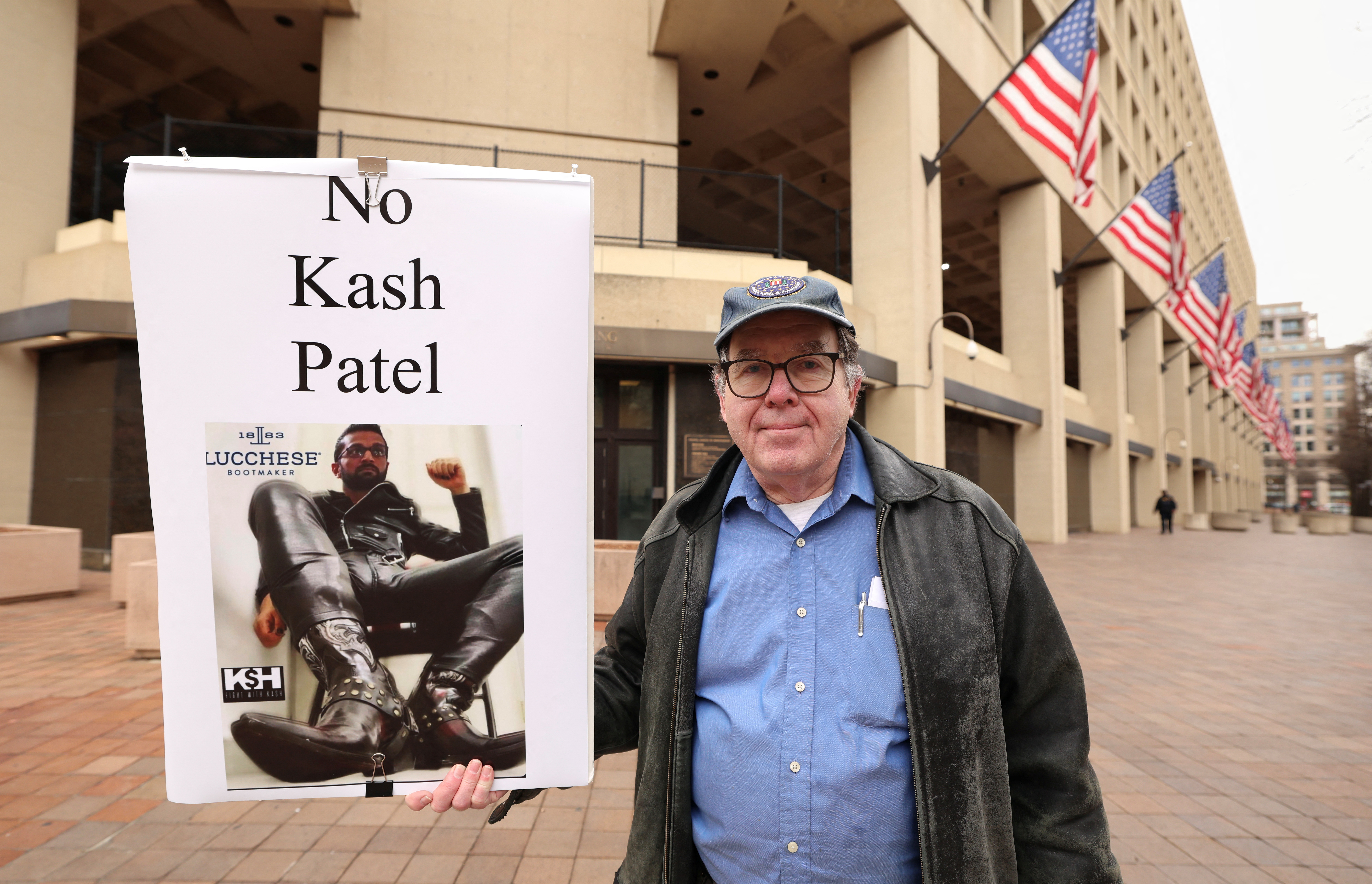 Stephen Butterfield of Washington, DC, holds a sign outside the FBI headquarters protesting Kash Patel on February 3