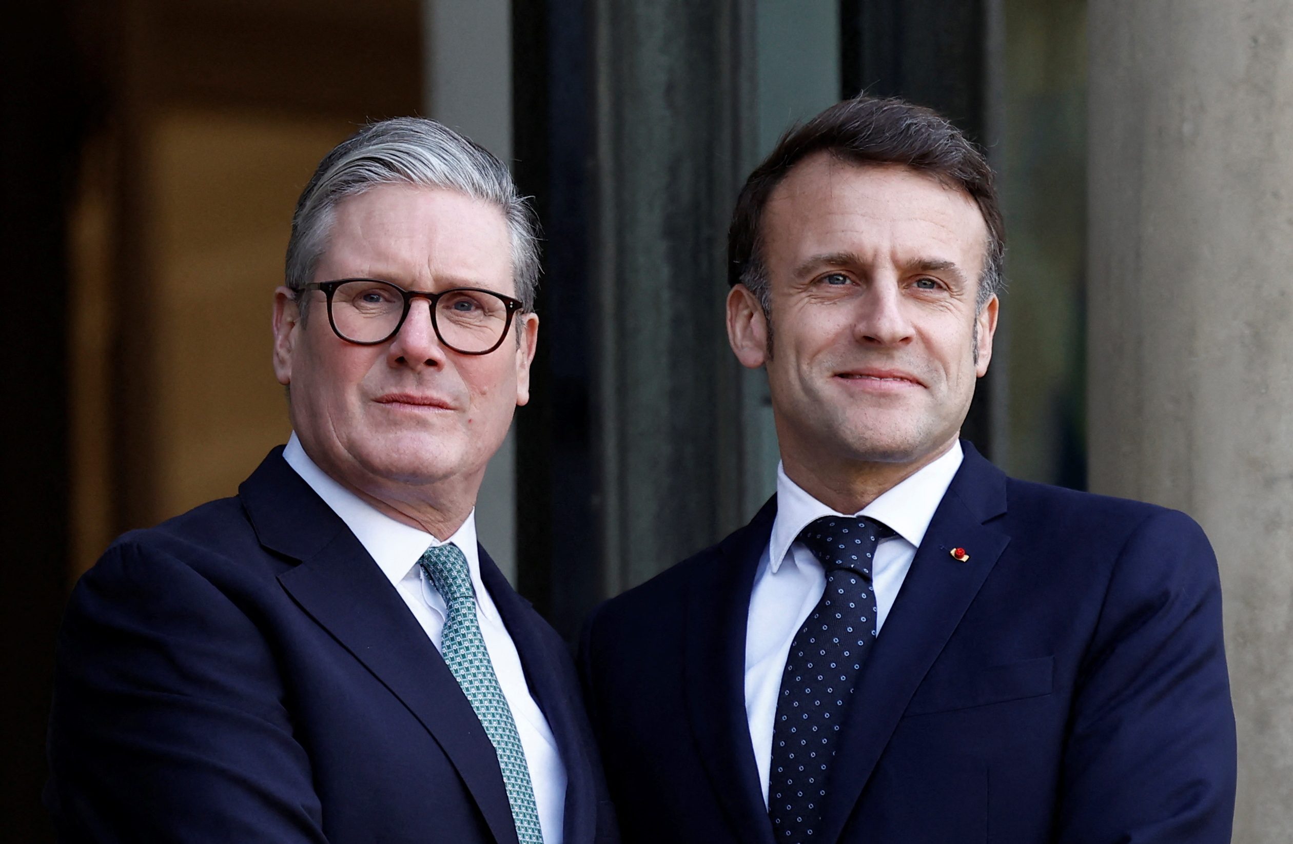 French President Emmanuel Macron welcomes Britain's Prime Minister Keir Starmer as he arrives for a meeting with European leaders on Ukraine and European security at the Elysee Palace in Paris, France, February 17, 2025.