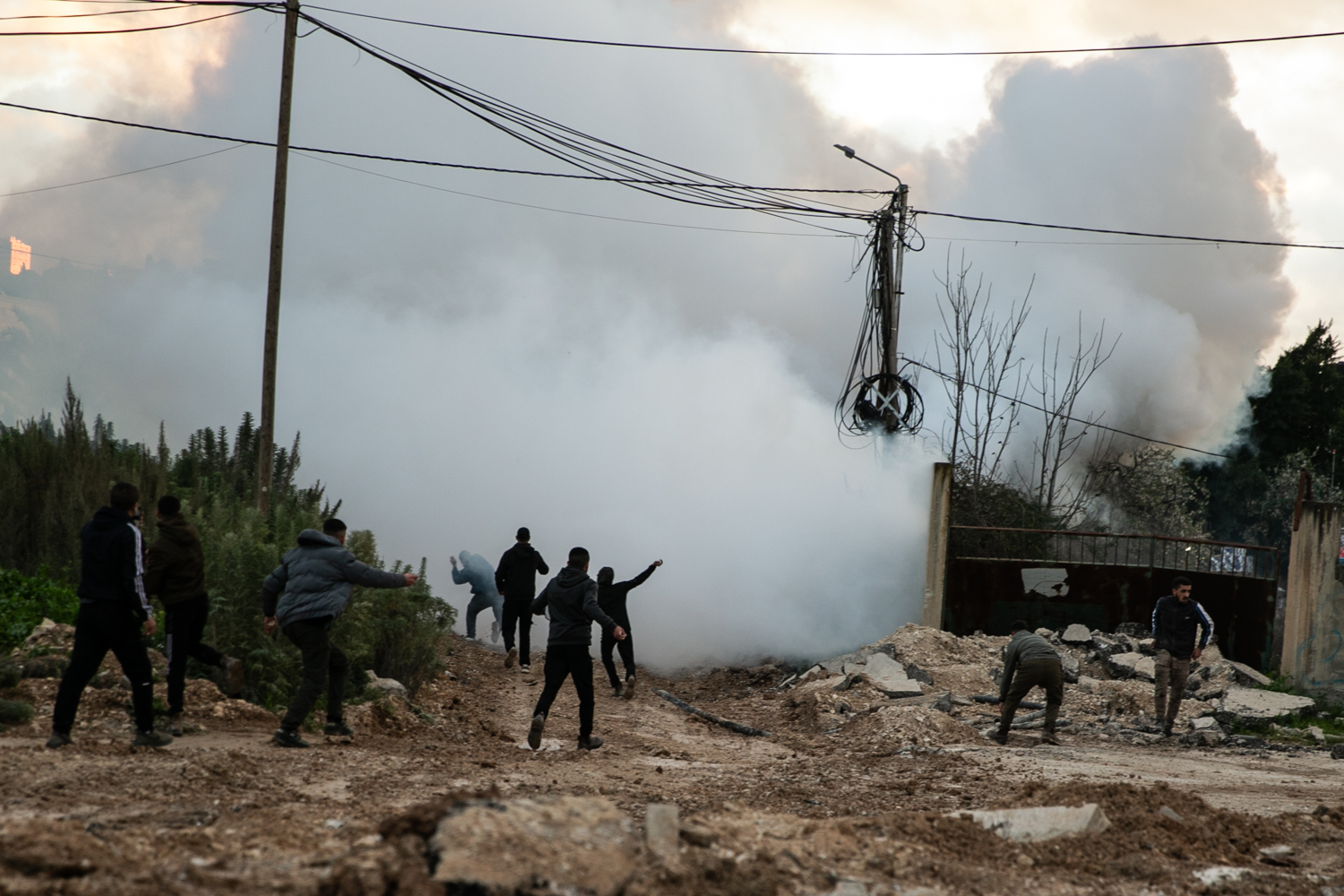 Palestinian youth gathered around the Israeli tanks and bulldozers [Al Jazeera]