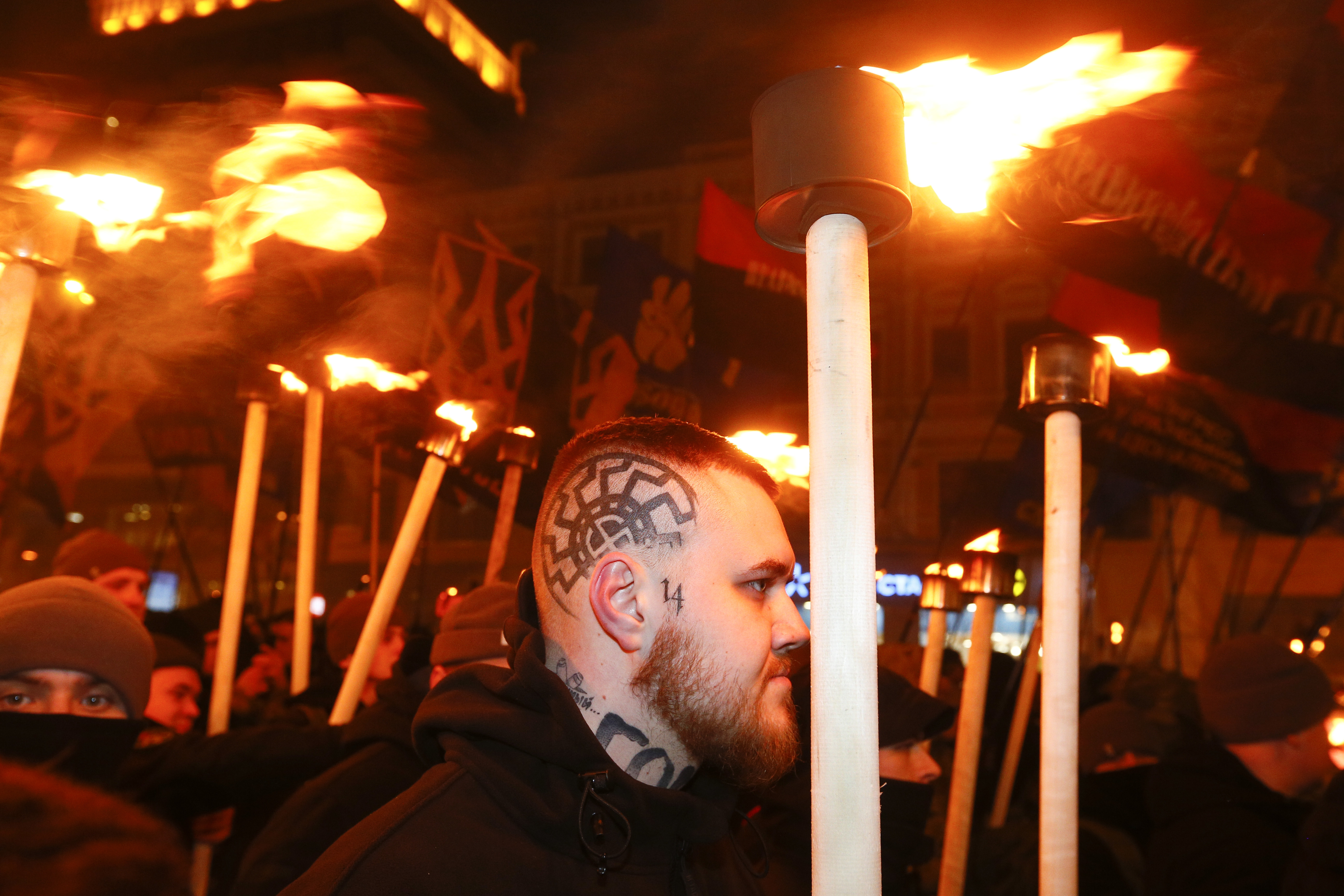 Activists of various nationalist parties carry torches during a rally in Kiev, Ukraine, Monday, Jan. 1, 2018. The rally was organized on the occasion of the birth anniversary of Stepan Bandera, founder of a rebel army that fought against the Soviet regime and who was assassinated in Germany in 1959. (AP Photo/(AP Photo/Efrem Lukatsky)