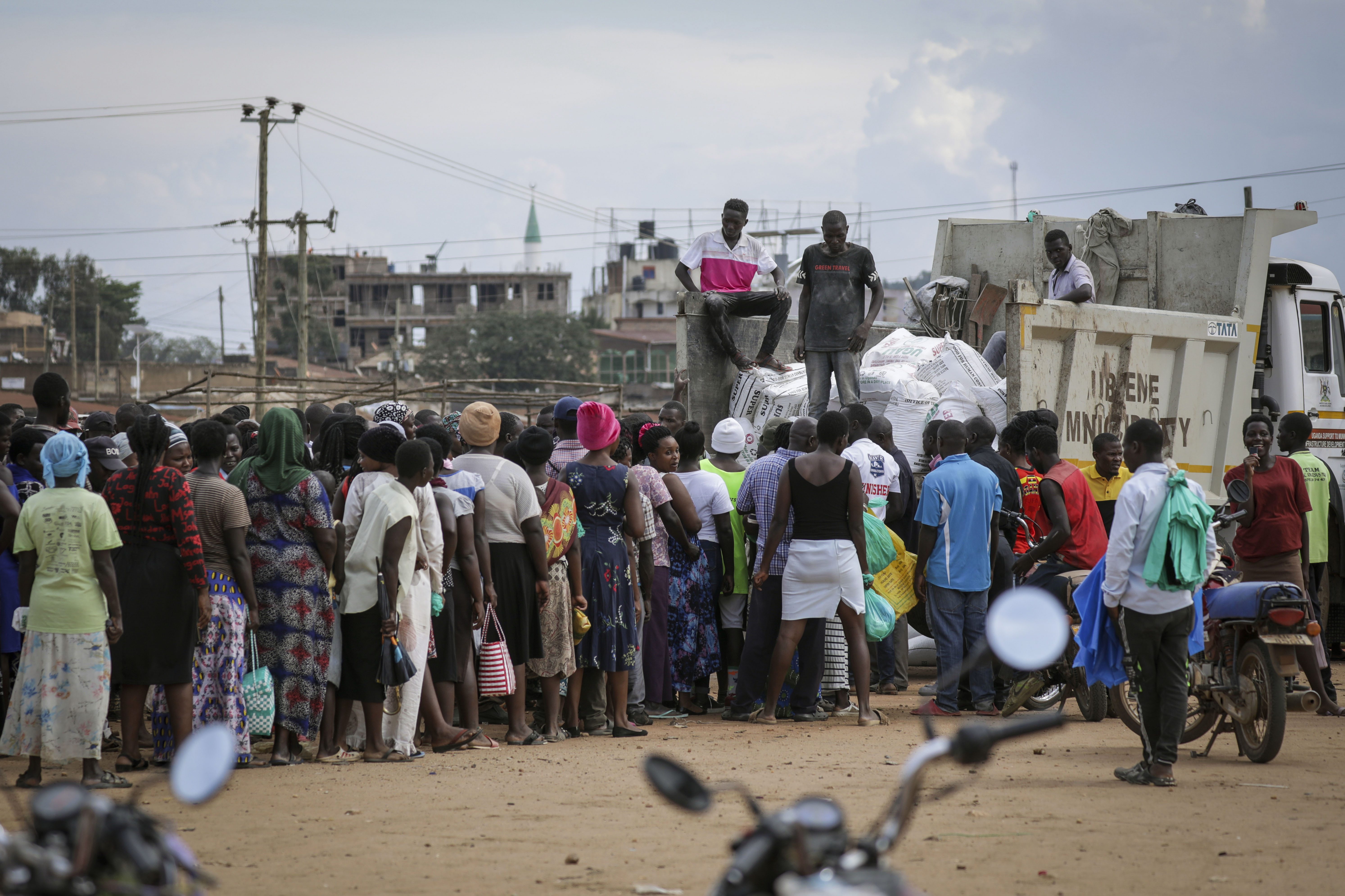 During the 2022 Ebola outbreak, people waited for food distribution from trucks, as many people were affected by travel restrictions that curtailed their business activities and livelihoods