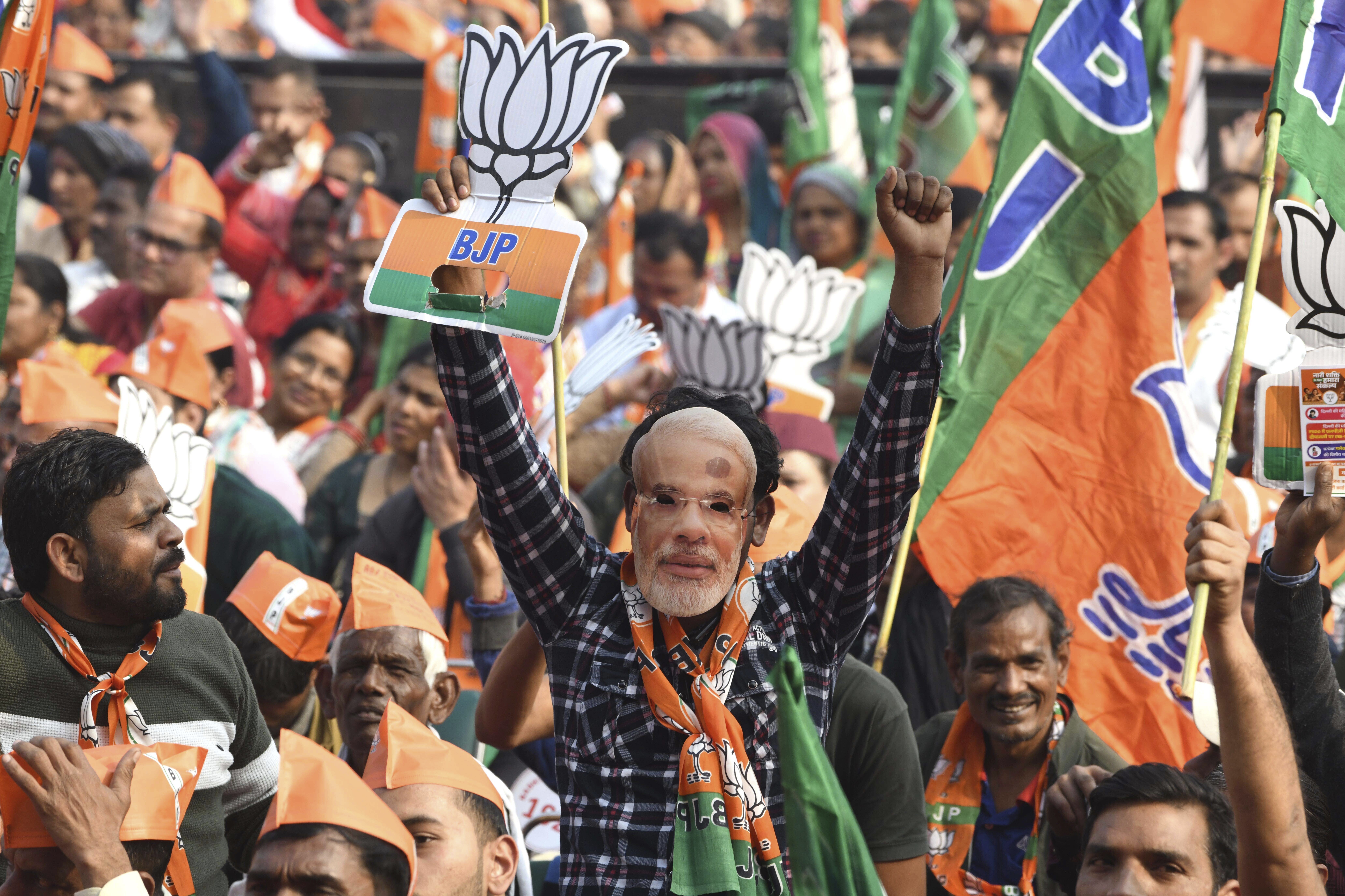 A BJP supporter wears a mask of Indian Prime Minister Narendra Modi during a Delhi state election campaign rally in New Delhi, India, on Friday, January 31, 2025 [AP Photo]